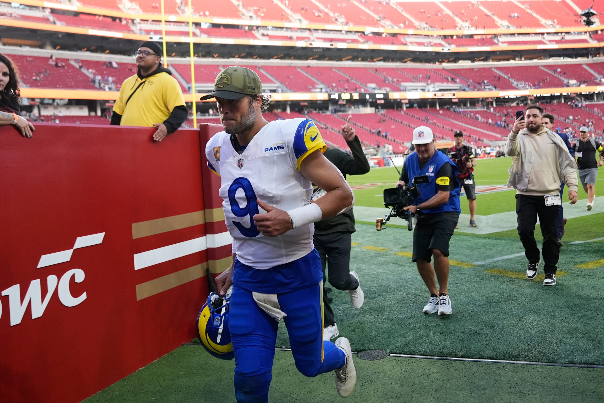 Rams quarterback Matthew Stafford (9) jogs off the field after...
