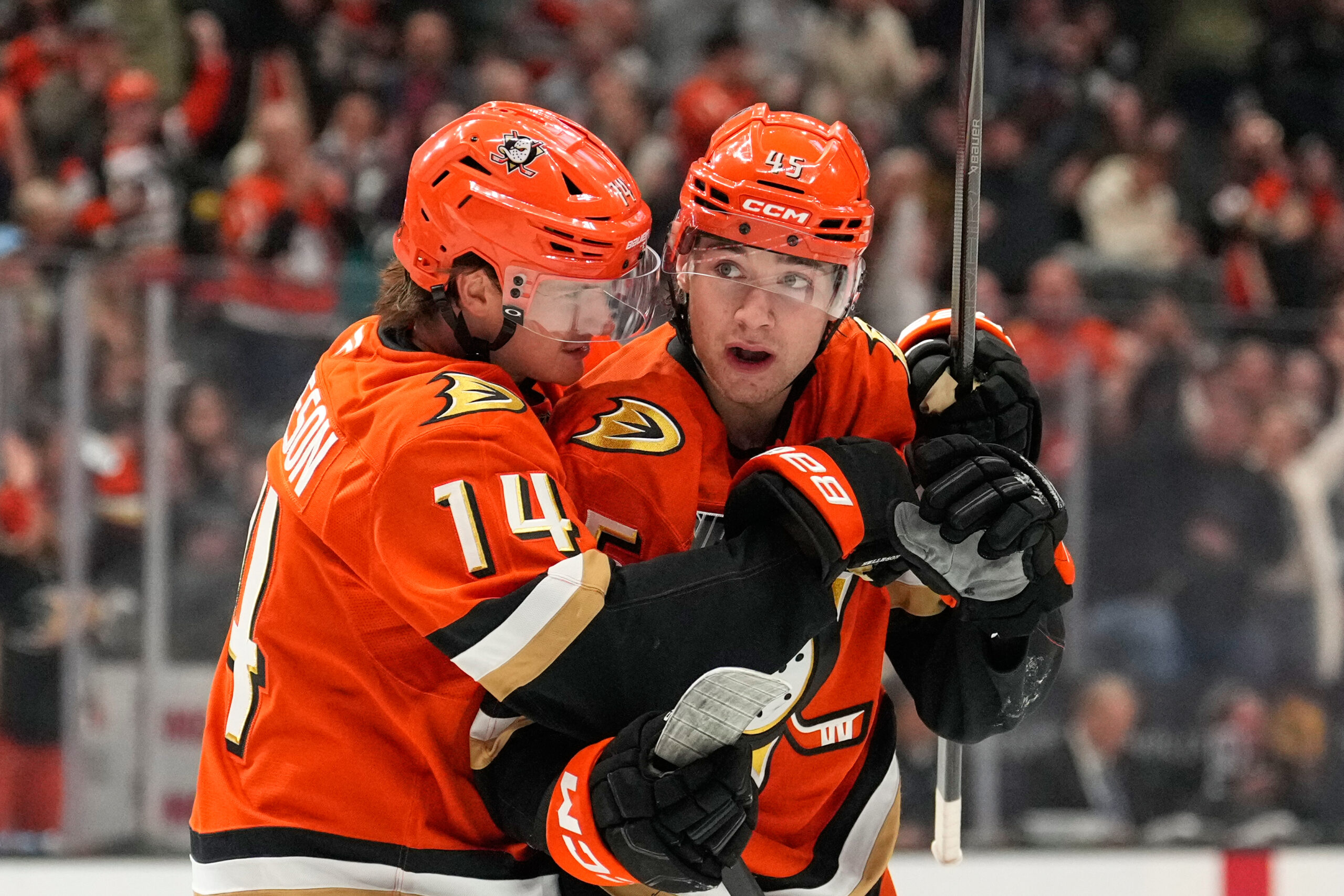 Ducks right wing Beckett Sennecke, right, celebrates his goal with...
