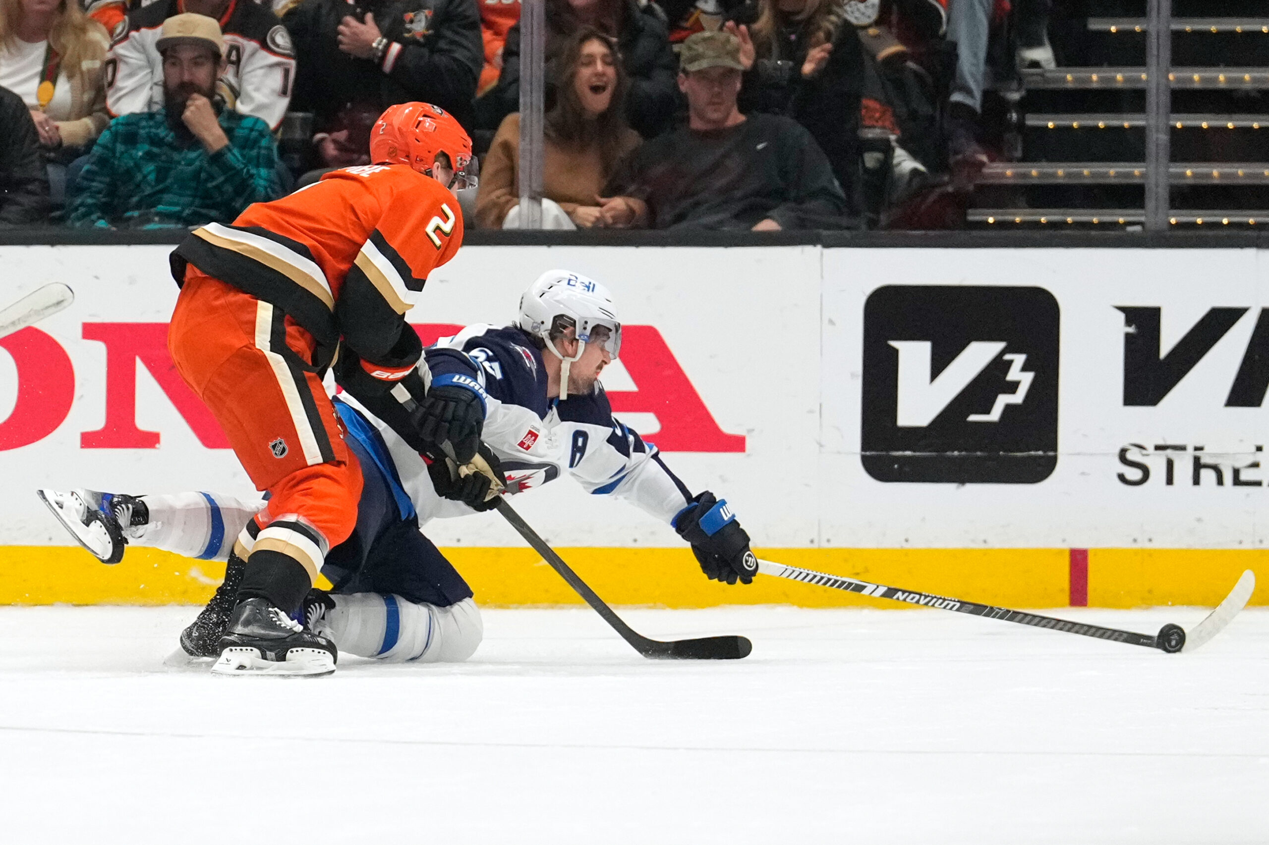 Winnipeg Jets center Mark Scheifelem right, reaches for the puck...