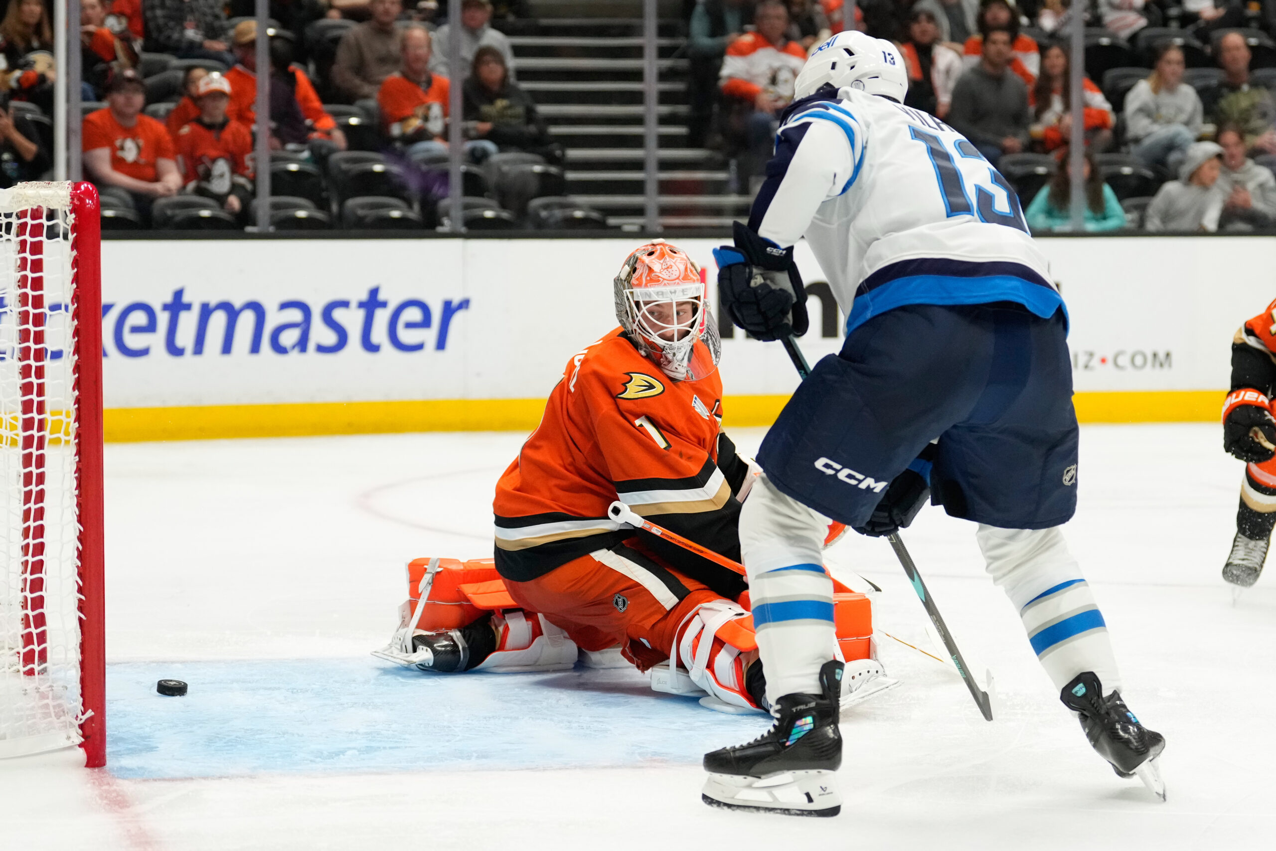 Ducks goaltender Lukas Dostal, left is scored on by Winnipeg...