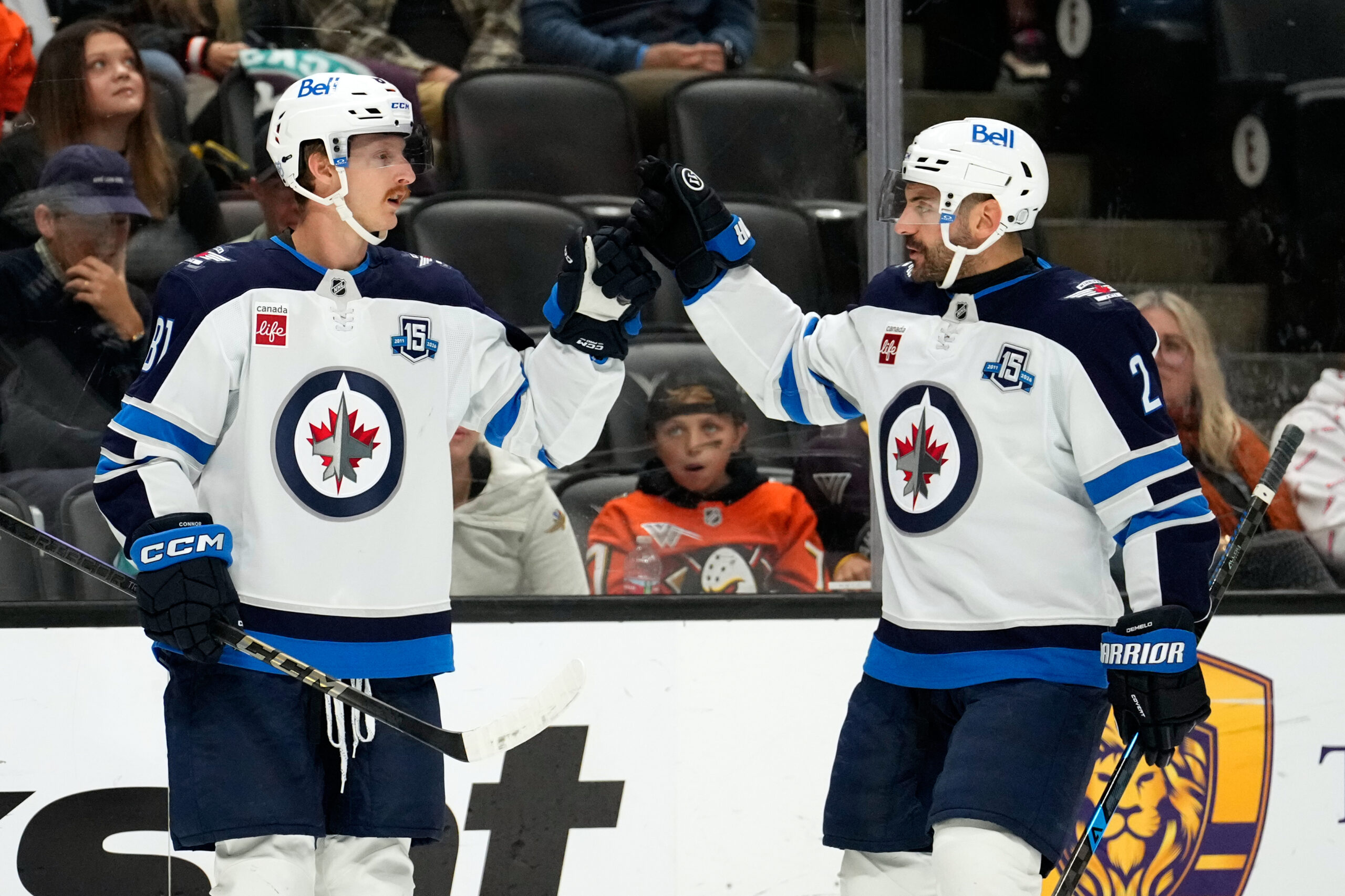 Winnipeg Jets left wing Kyle Connor, left, celebrates his goal...