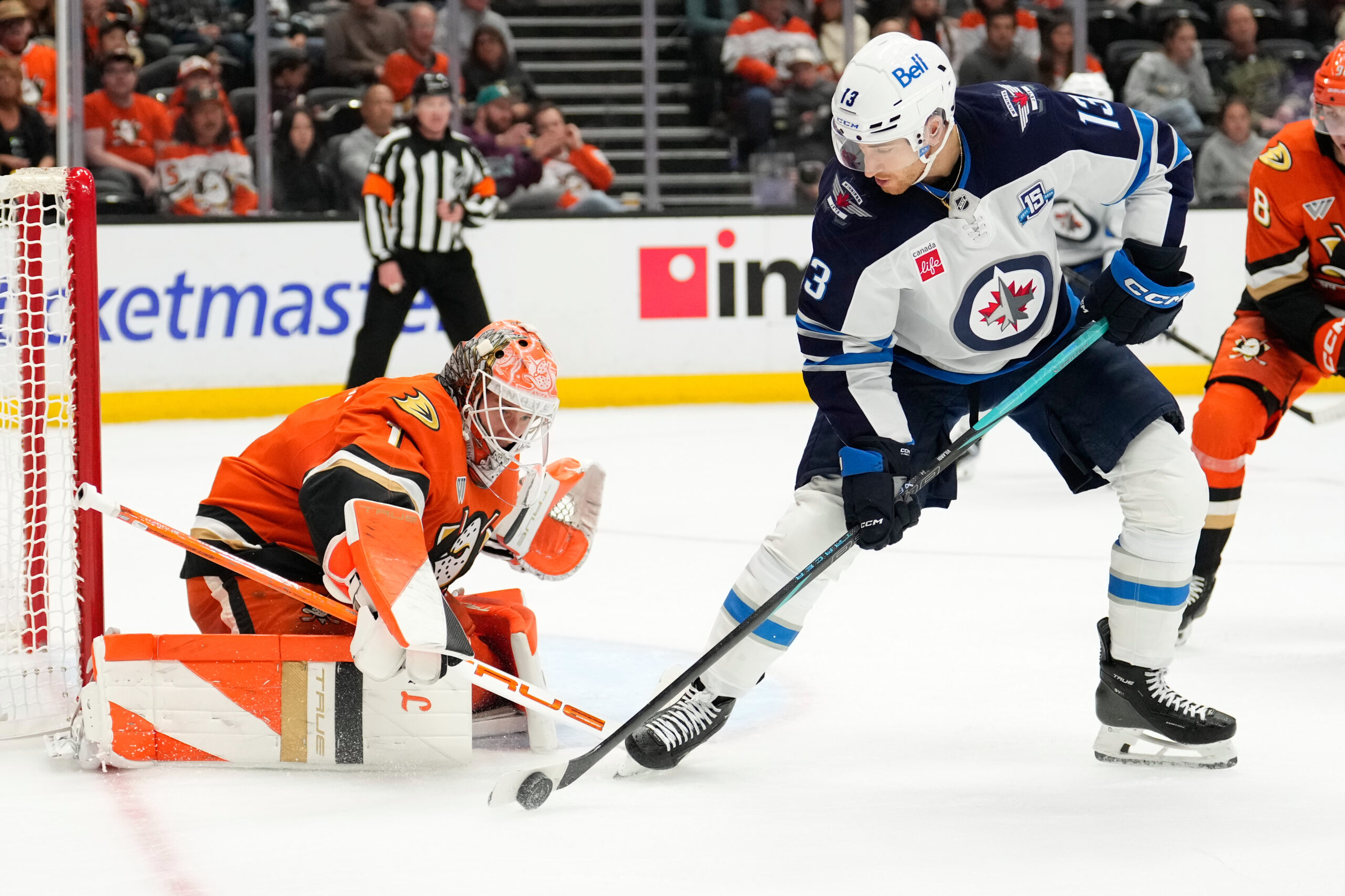 Winnipeg Jets center Gabriel Vilardi right, tries to get a...