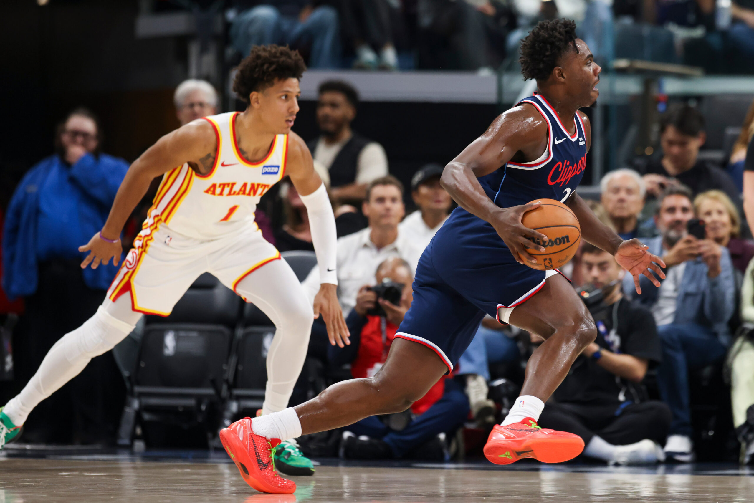 Clippers guard Kobe Brown, right, dribbles as Atlanta Hawks forward...
