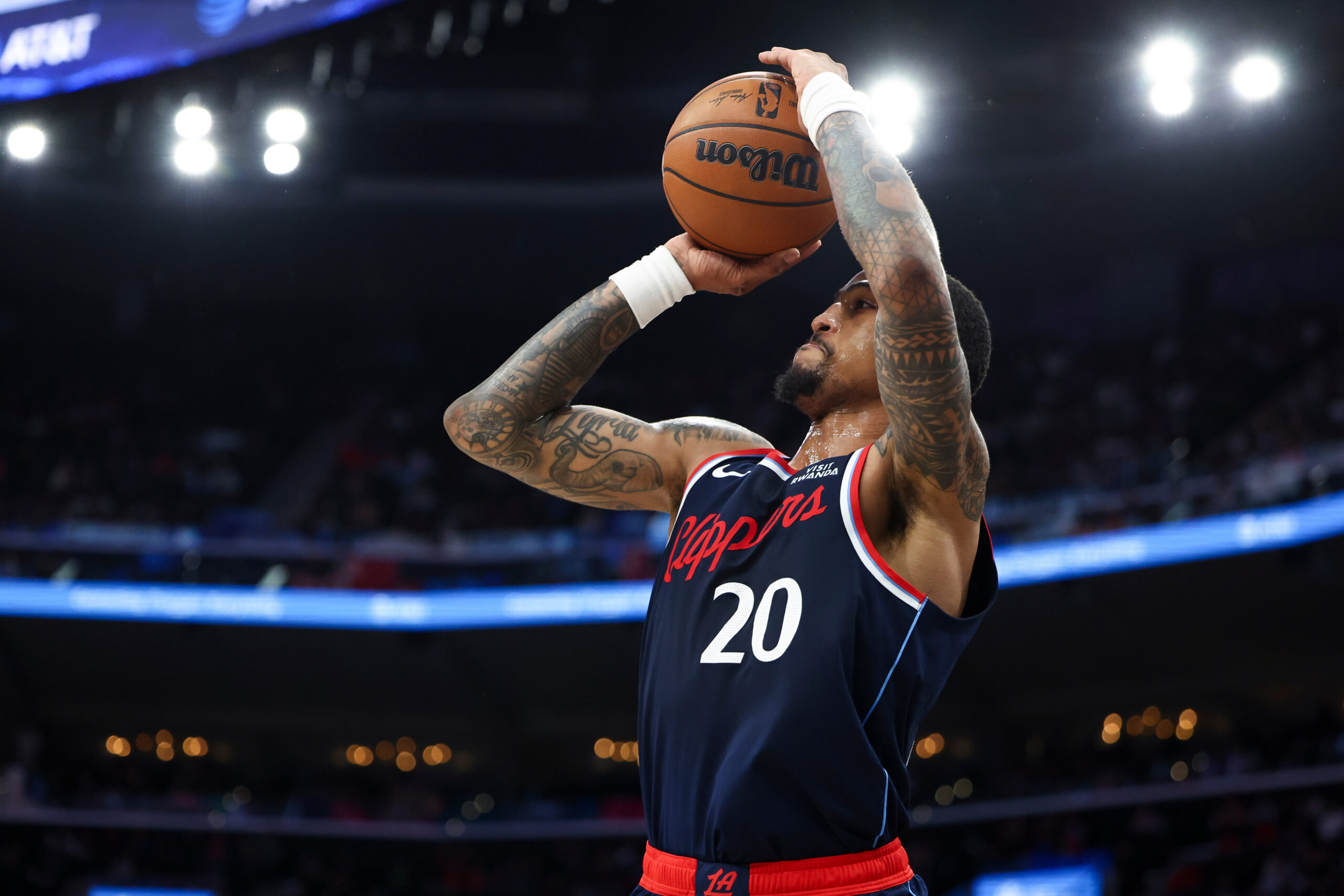 Clippers forward John Collins (20) takes a 3-point shot against...