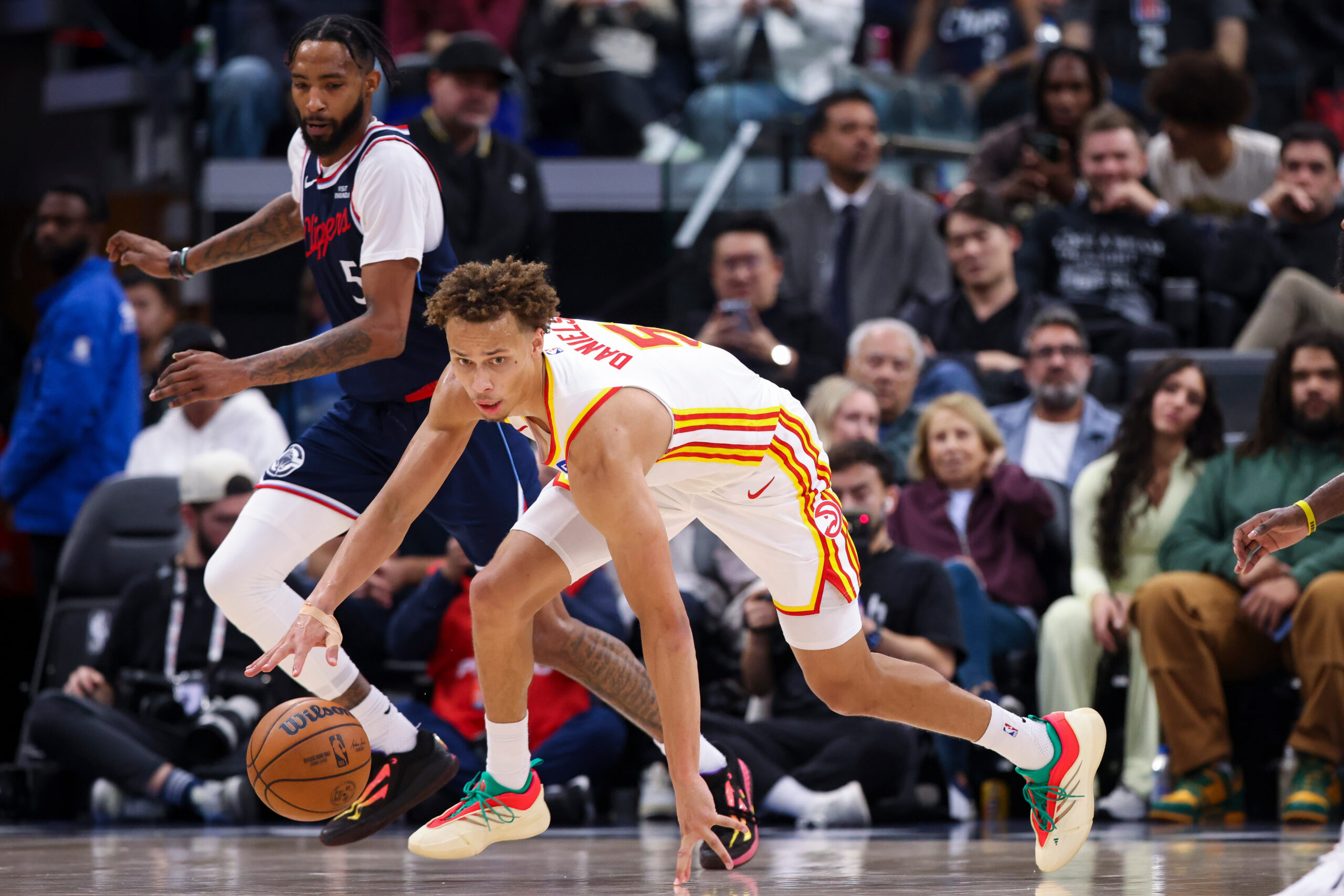 Atlanta Hawks guard Dyson Daniels (5), front, dribbles the ball...