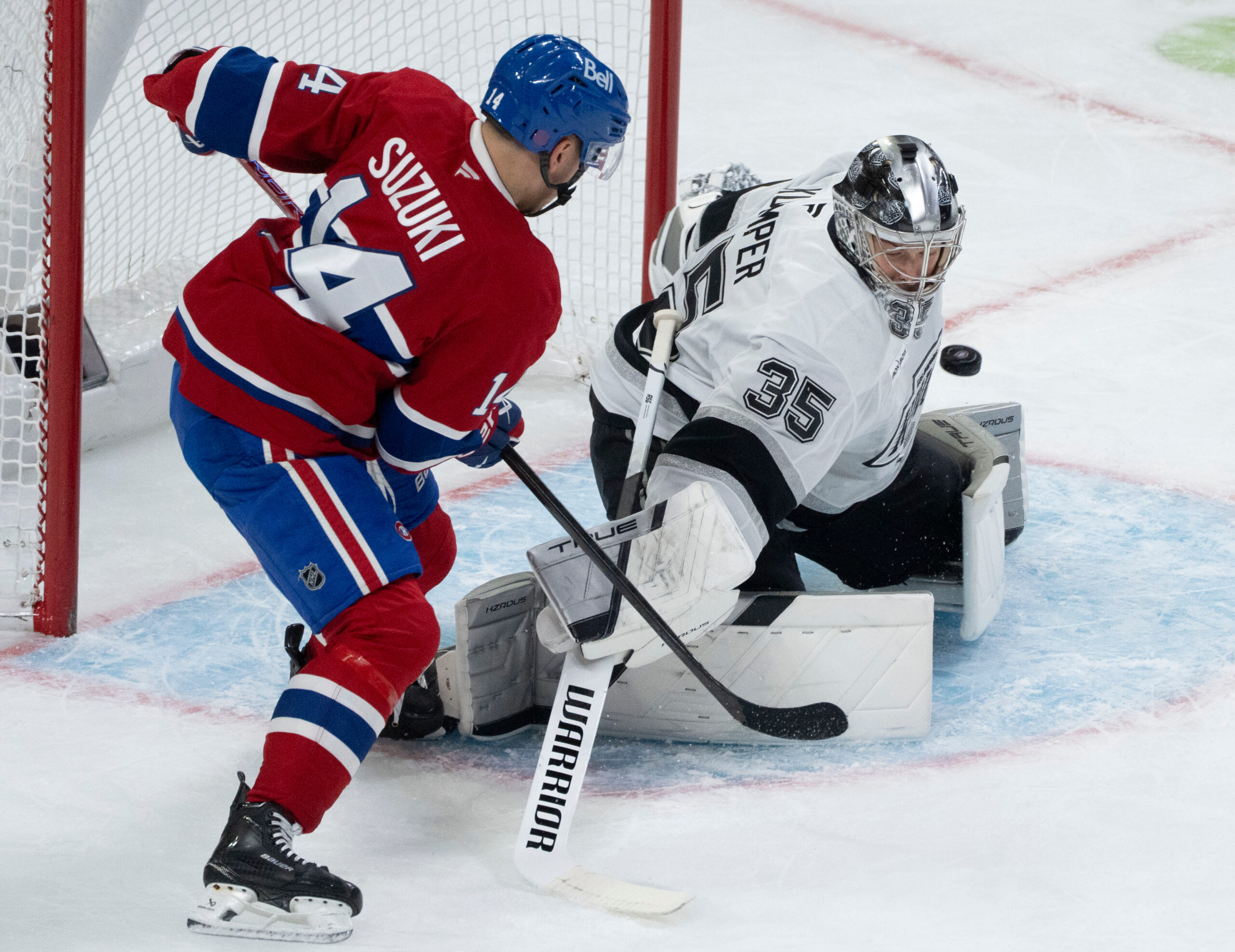 Kings goaltender Darcy Kuemper, right, stops a shot by the...