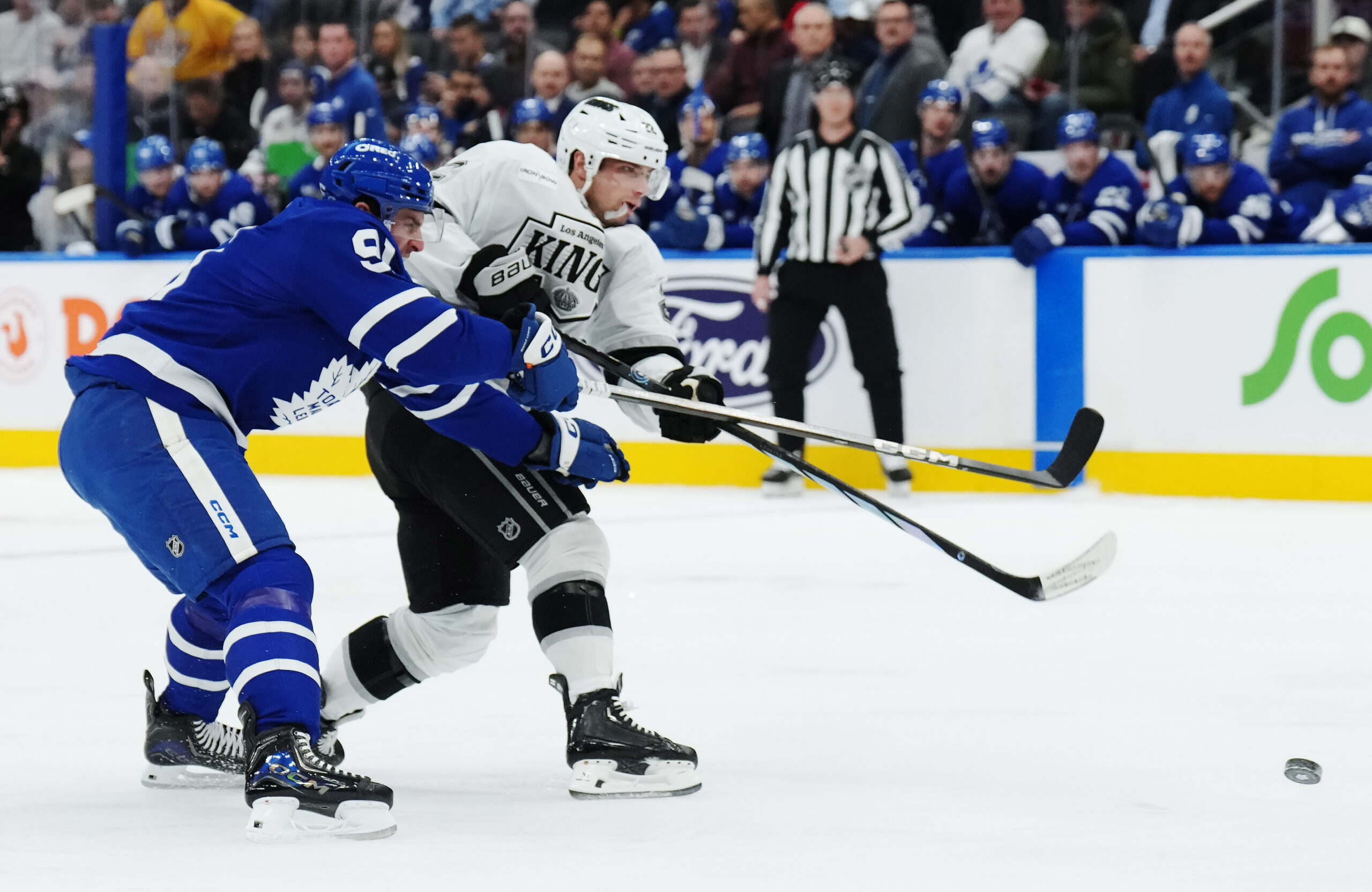 The Kings’ Kevin Fiala, right, shoots as the Toronto Maple...