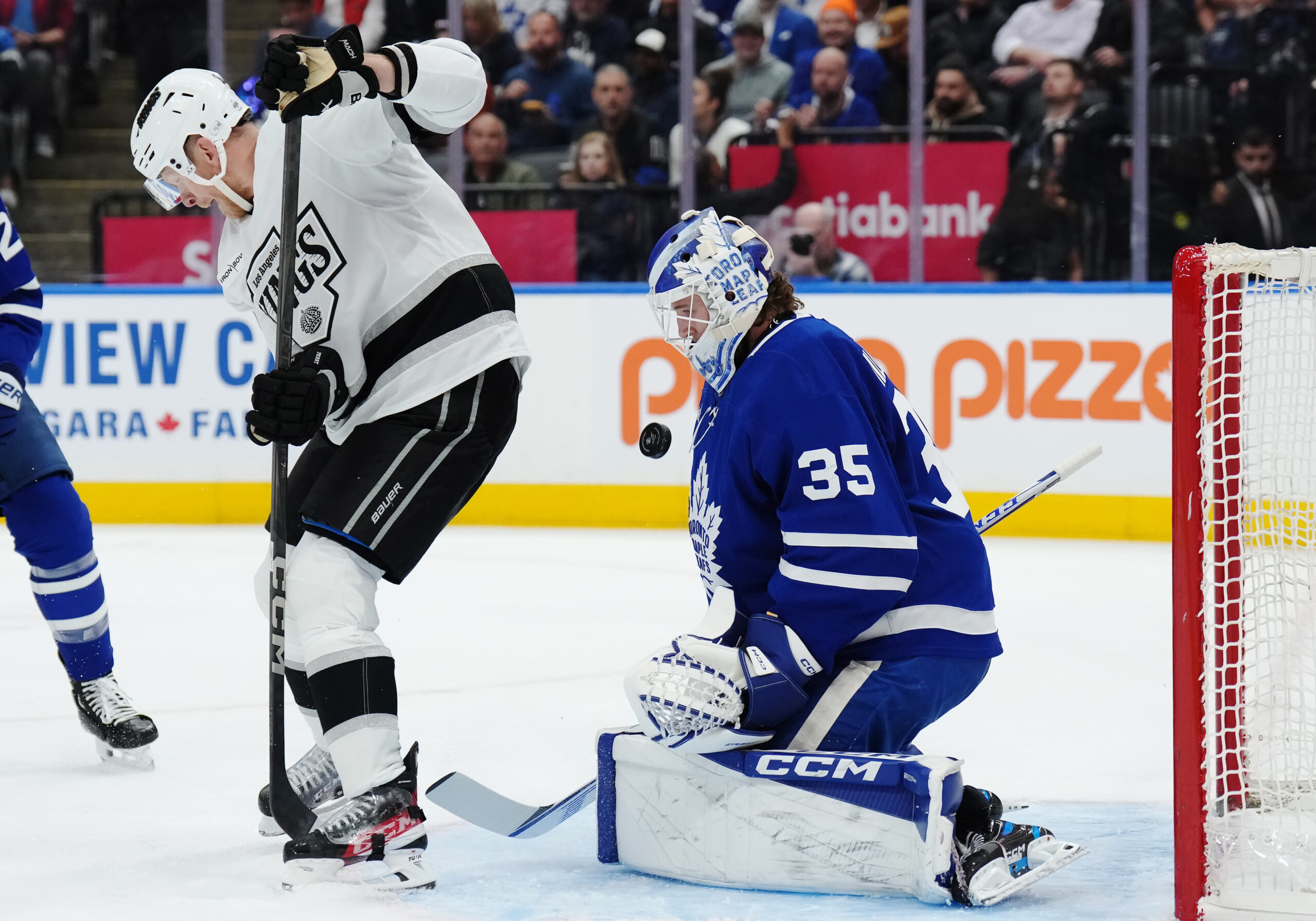 The Kings’ Corey Perry, left, tips the puck in front...