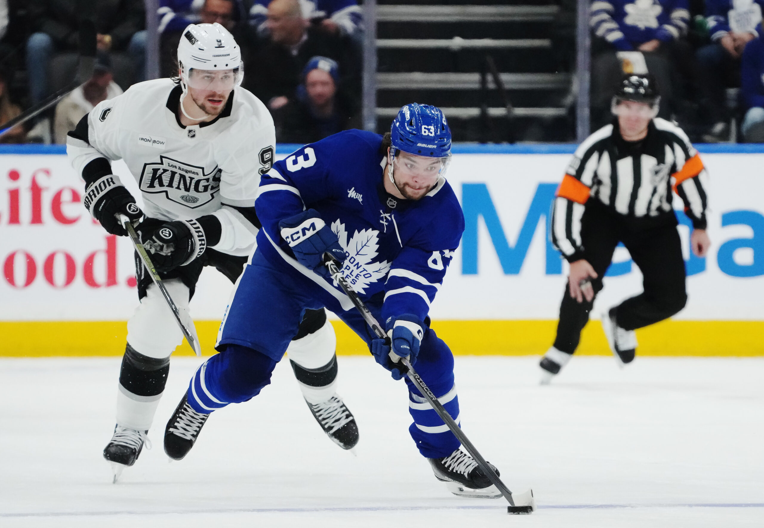 The Kings’ Adrian Kempe, left, chases the Toronto Maple Leafs’...