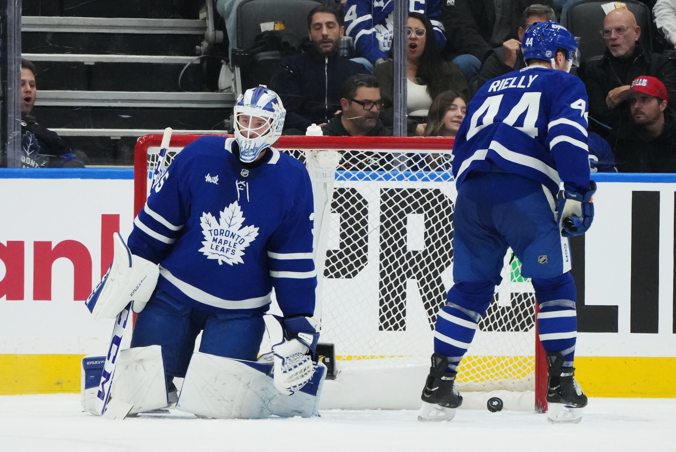 Toronto Maple Leafs goaltender Dennis Hildeby, left, and Morgan Rielly...
