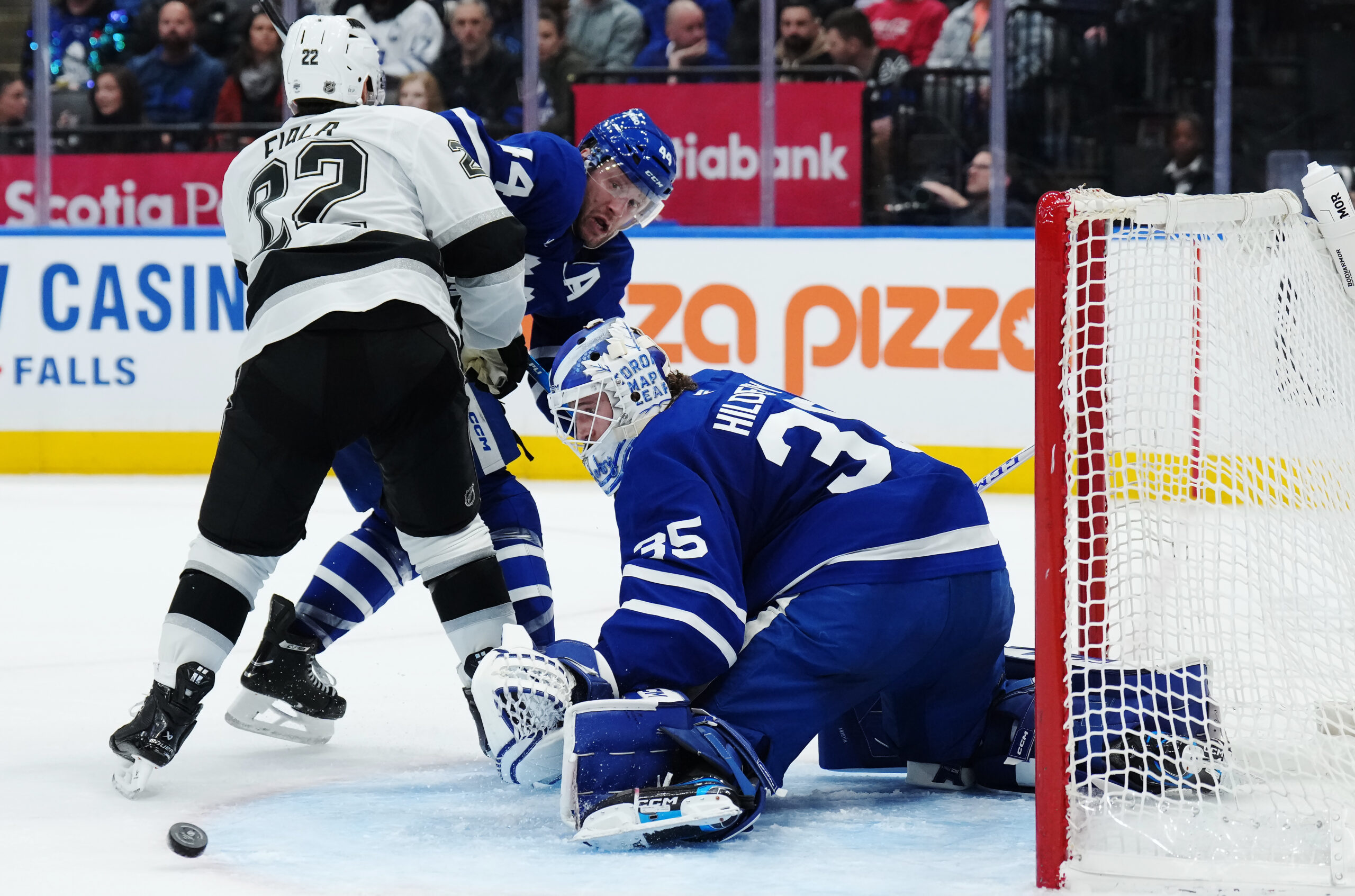 Toronto Maple Leafs goaltender Dennis Hildeby, right, makes a save...