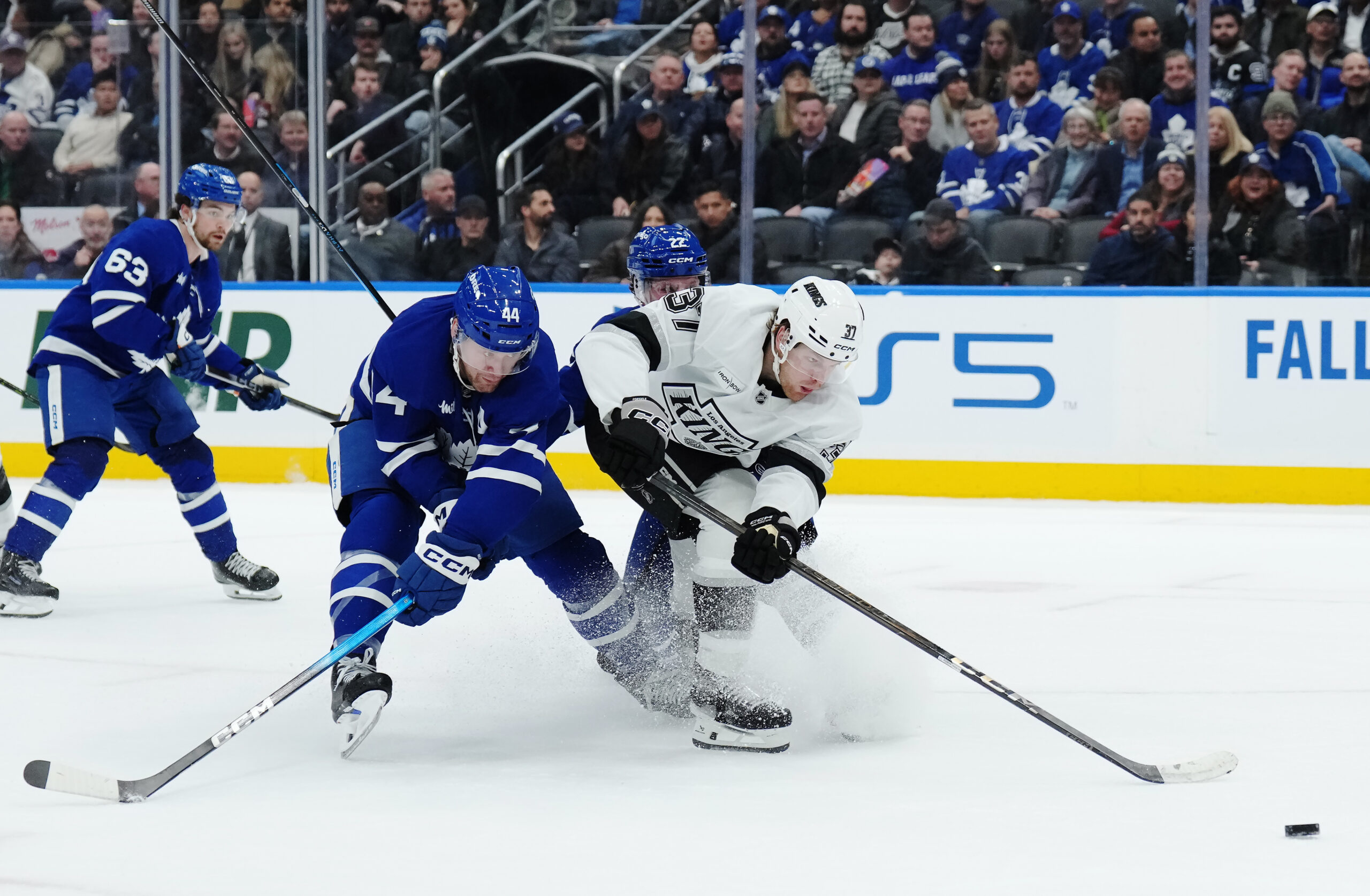 The Toronto Maple Leafs’ Morgan Rielly, left, battles with the...