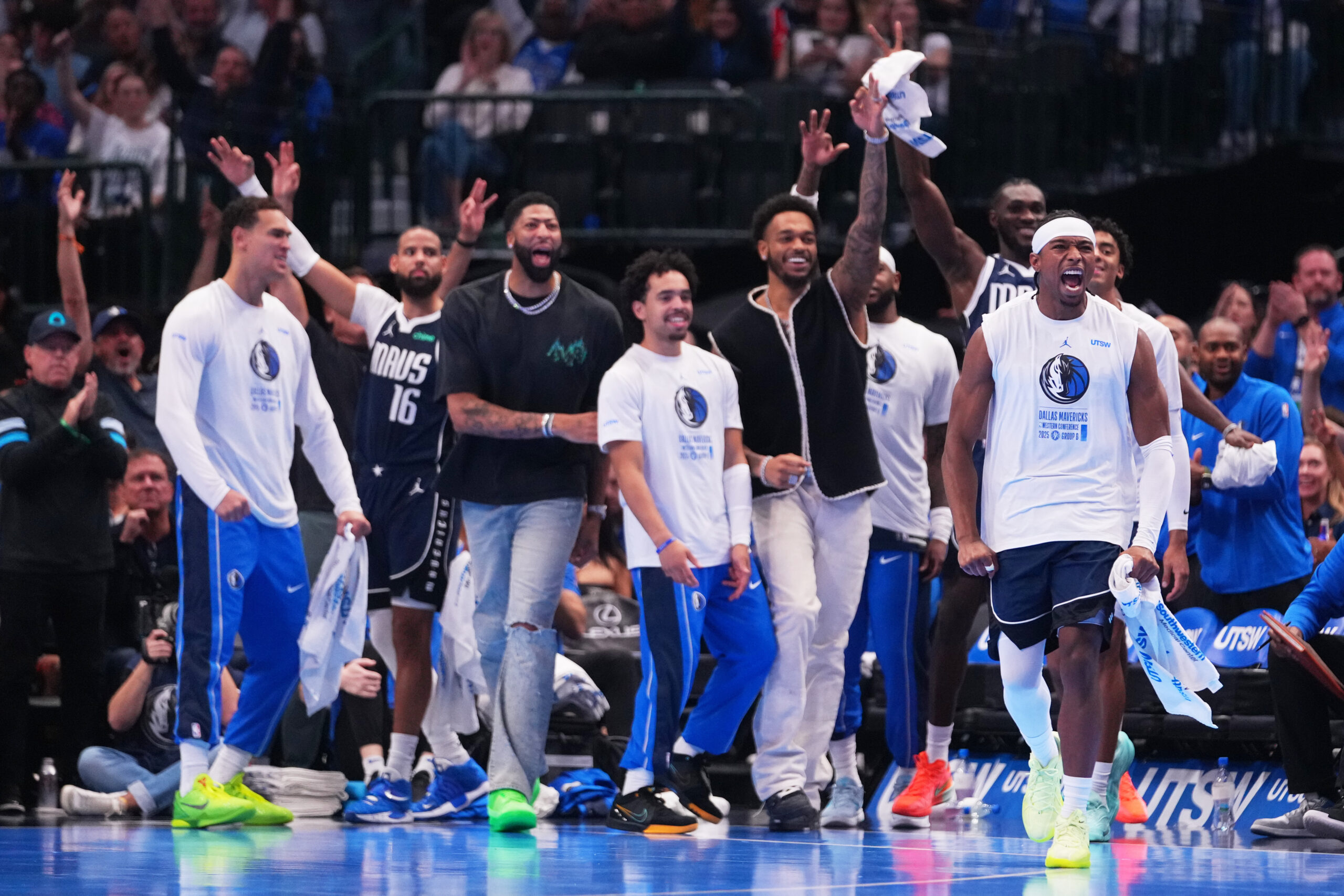Dallas Mavericks guard Brandon Williams, front right, and teammates react...