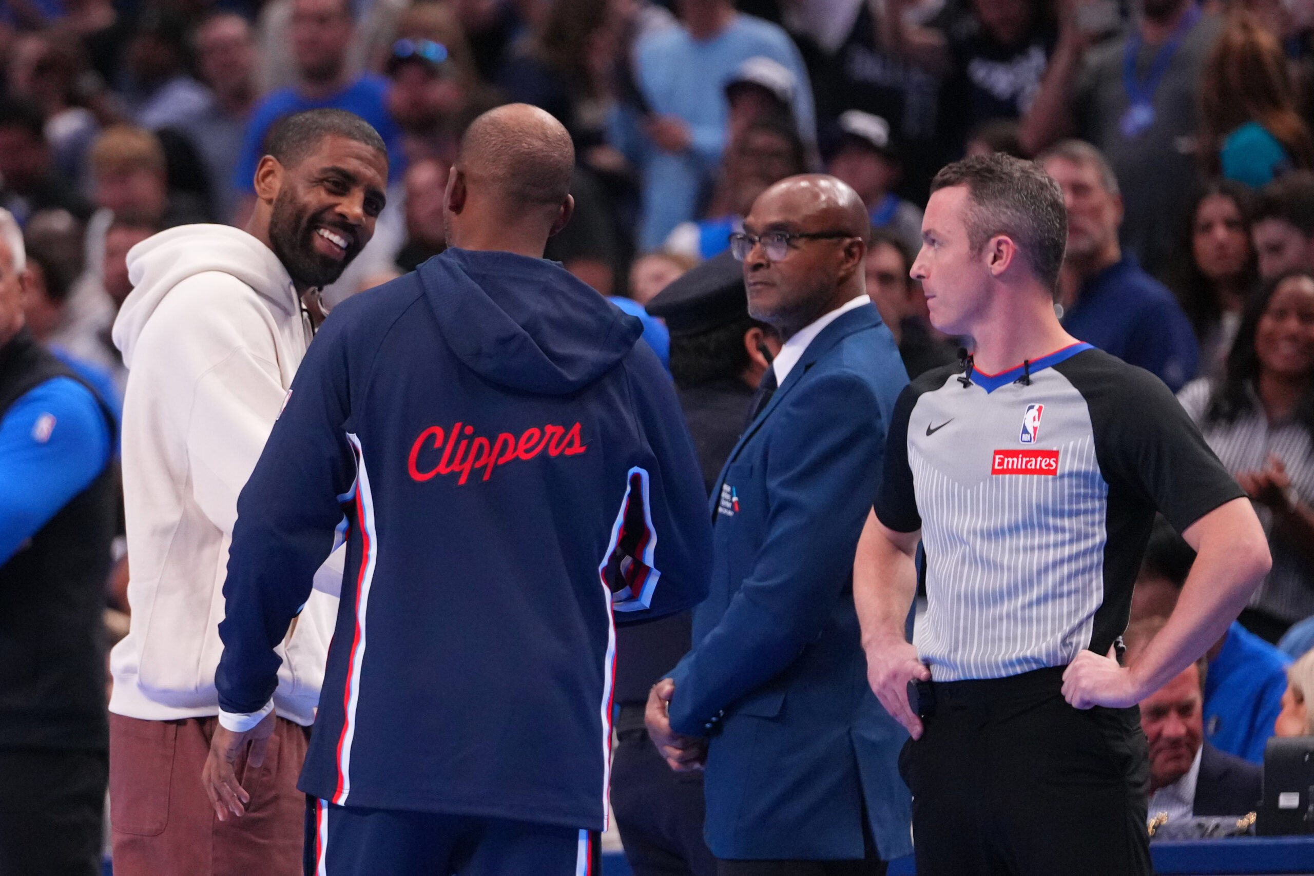 Injured Dallas Mavericks guard Kyrie Irving, left, talks with Clippers...