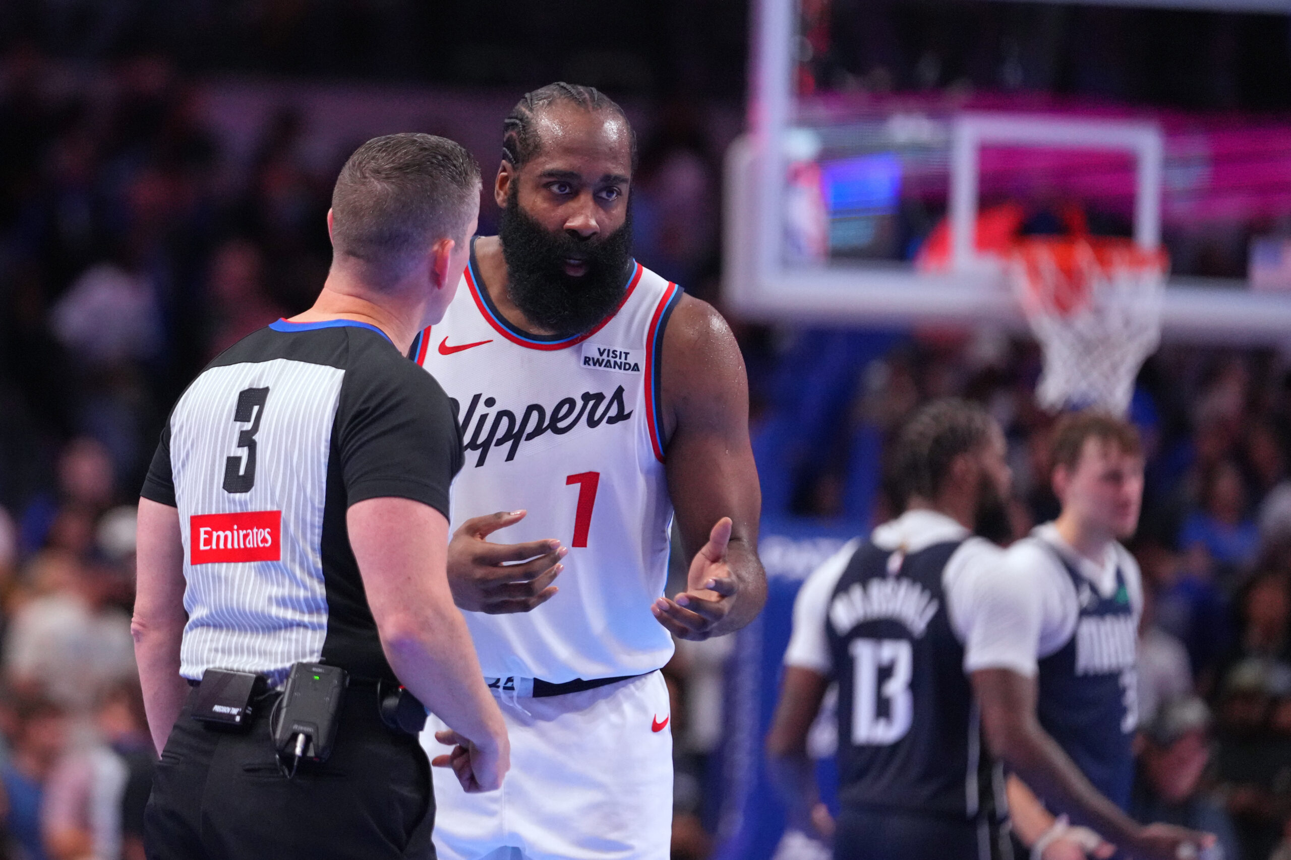 Clippers guard James Harden talks to referee Nick Buchert during...