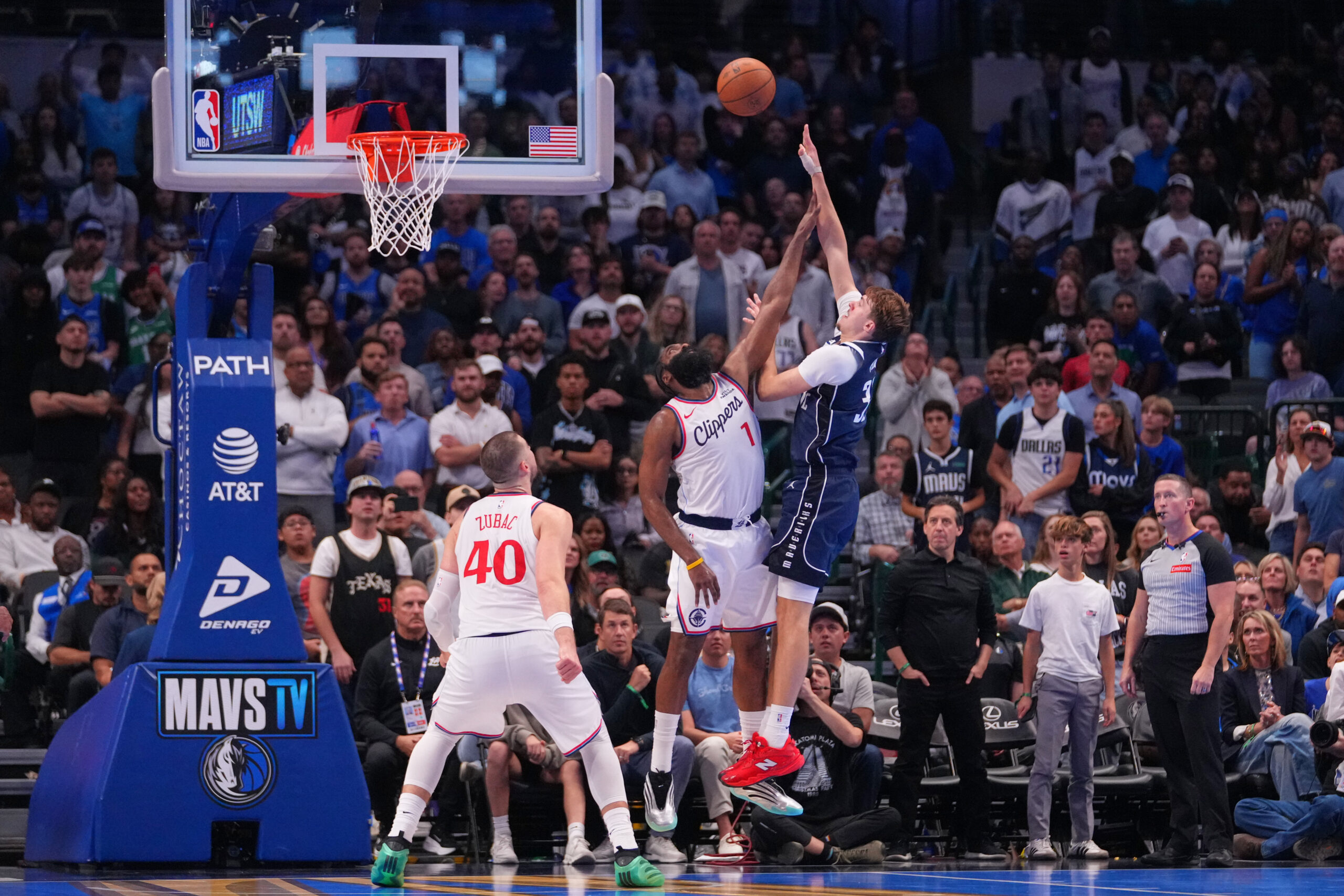 Dallas Mavericks forward Cooper Flagg, right, goes up for a...