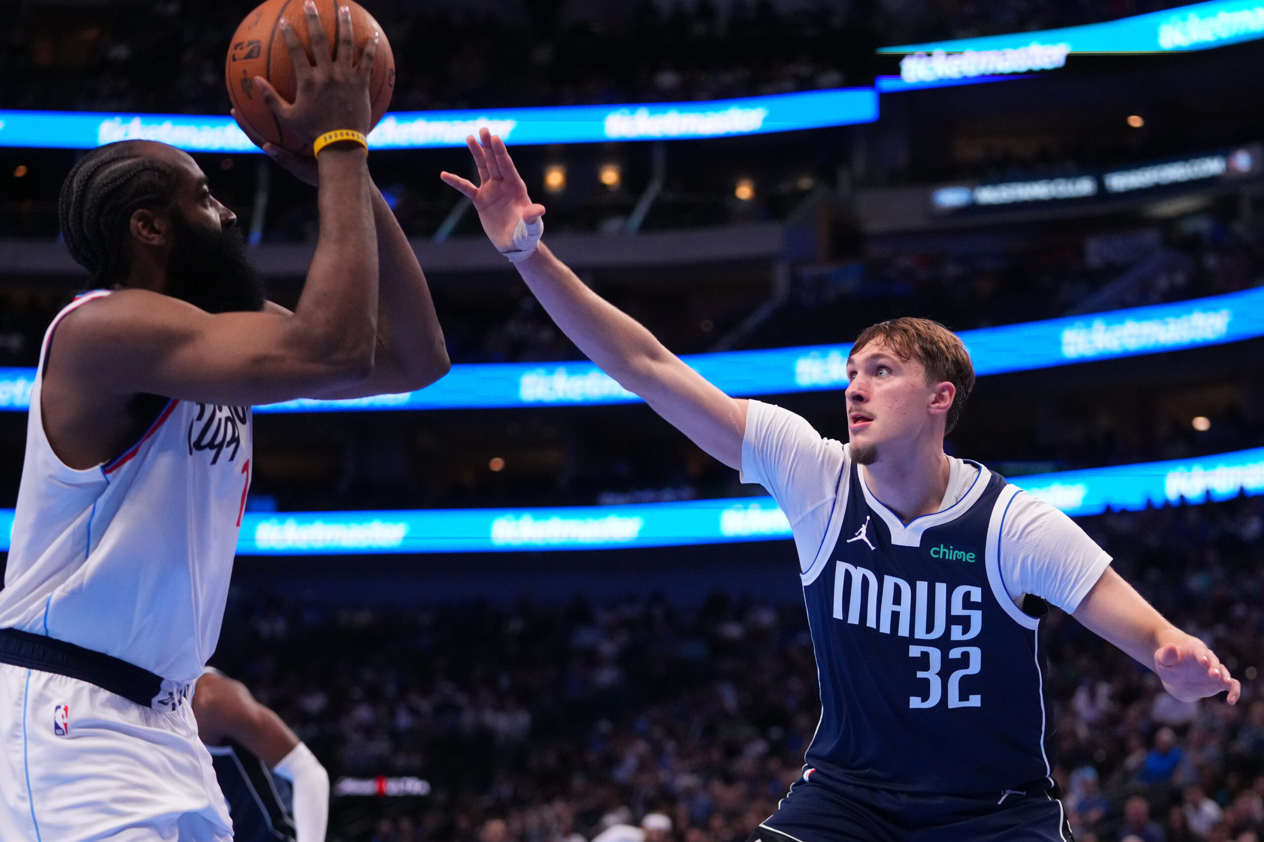 Clippers guard James Harden, left, attacks as Dallas Mavericks forward...