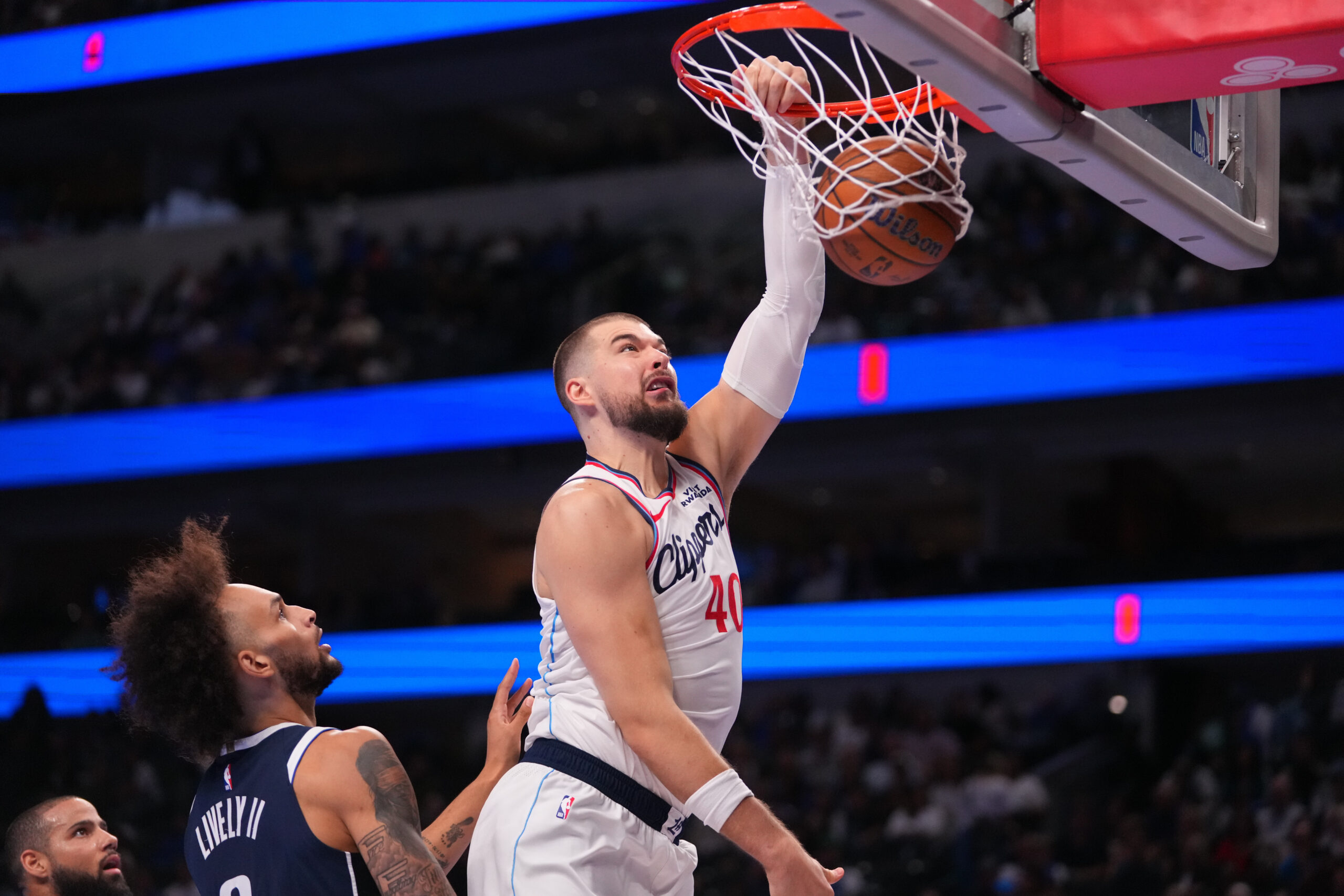 Clippers center Ivica Zubac dunks in front of Dallas Mavericks...