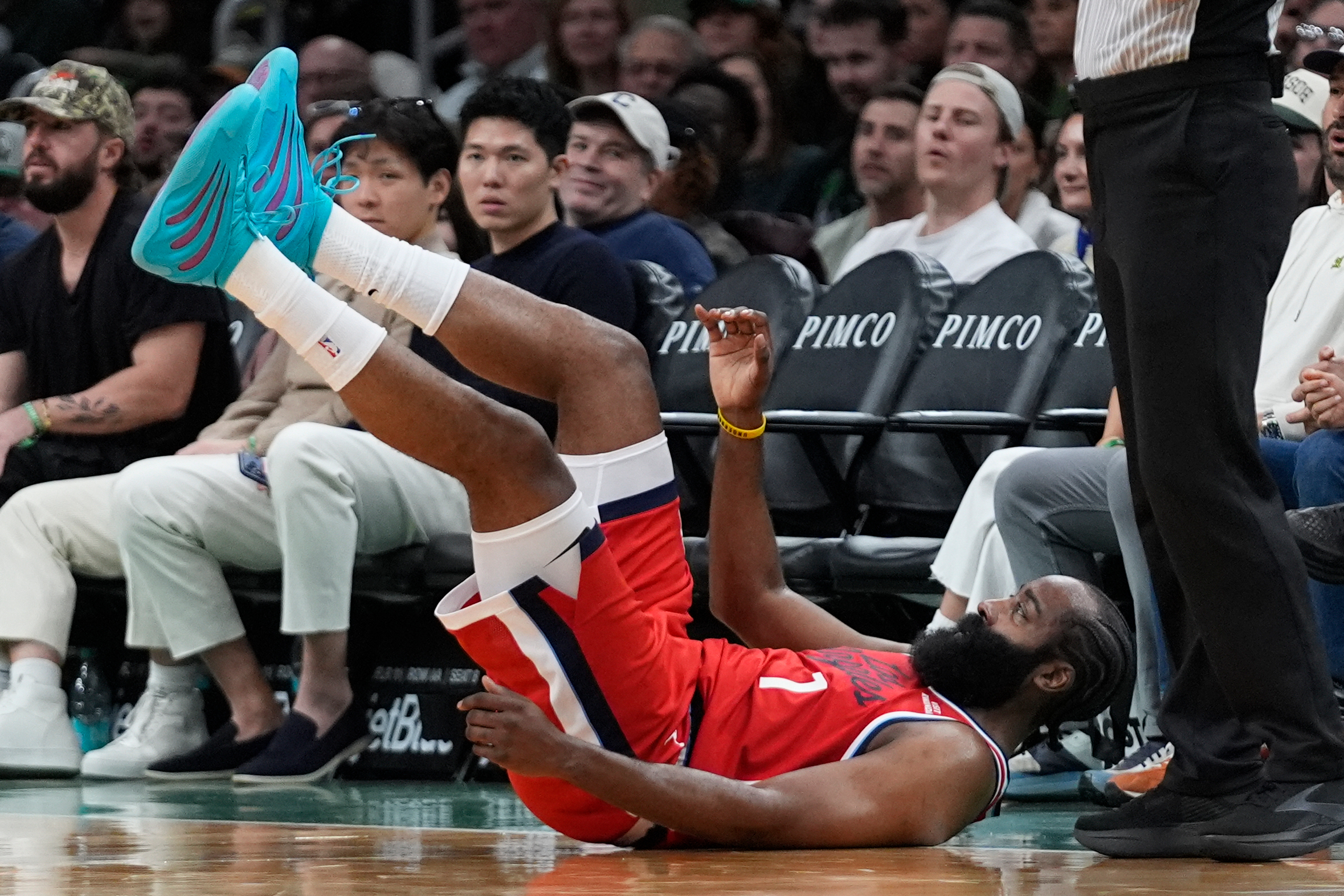 Clippers guard James Harden hits the floor after being fouled...