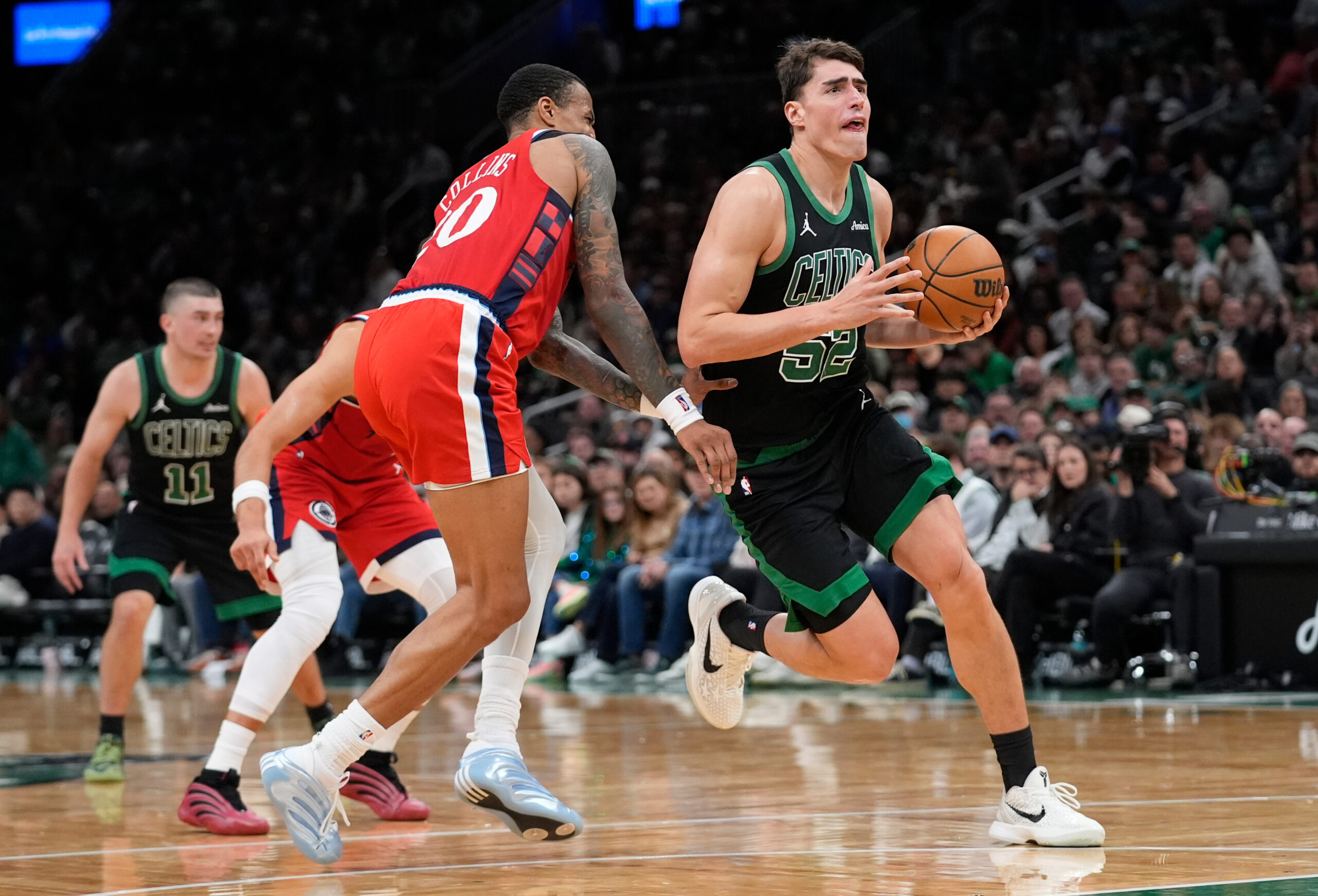 Boston Celtics center Luka Garza (52) drives to the net...