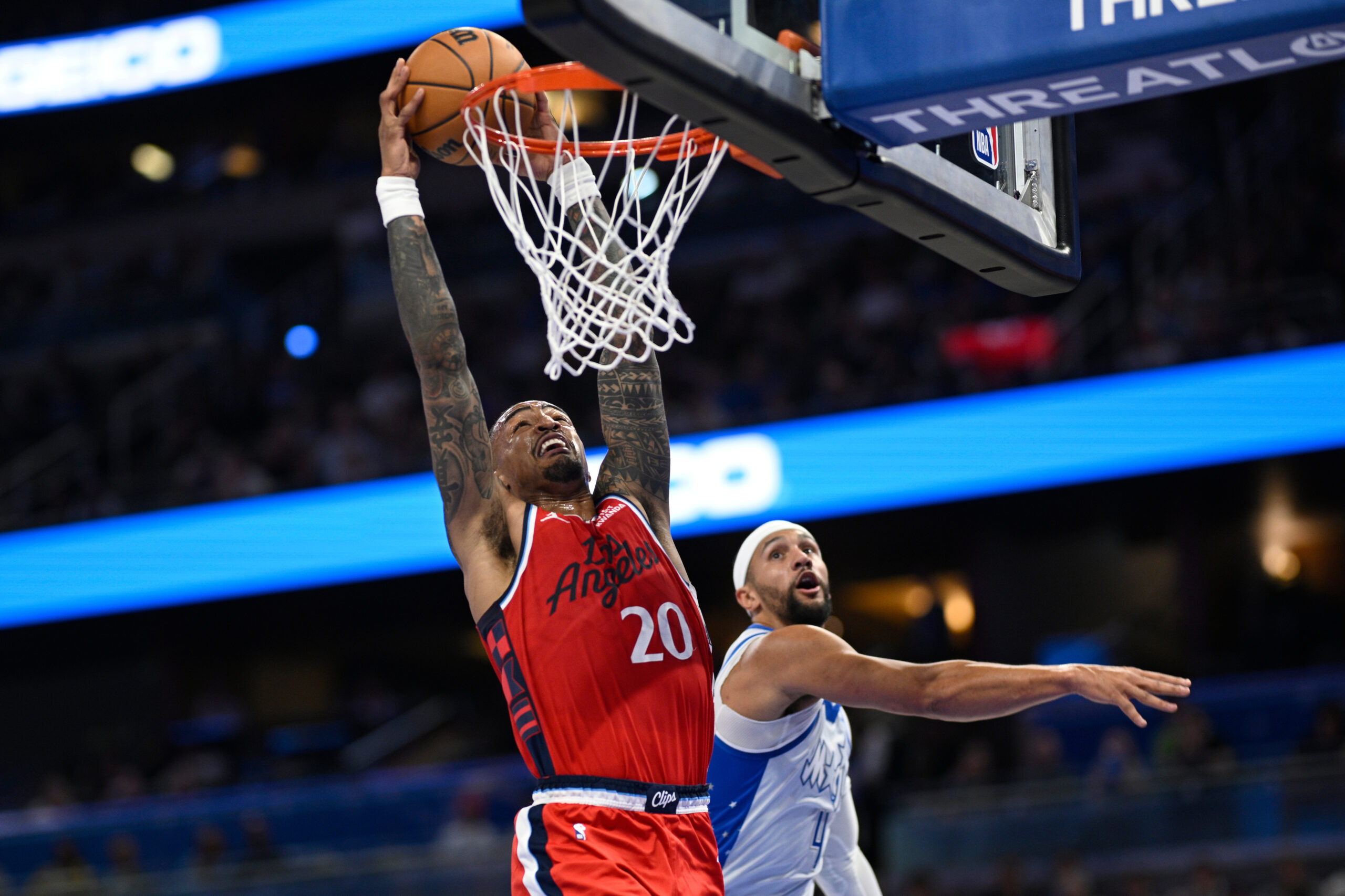 Clippers forward John Collins dunks as Orlando Magic guard Jalen...