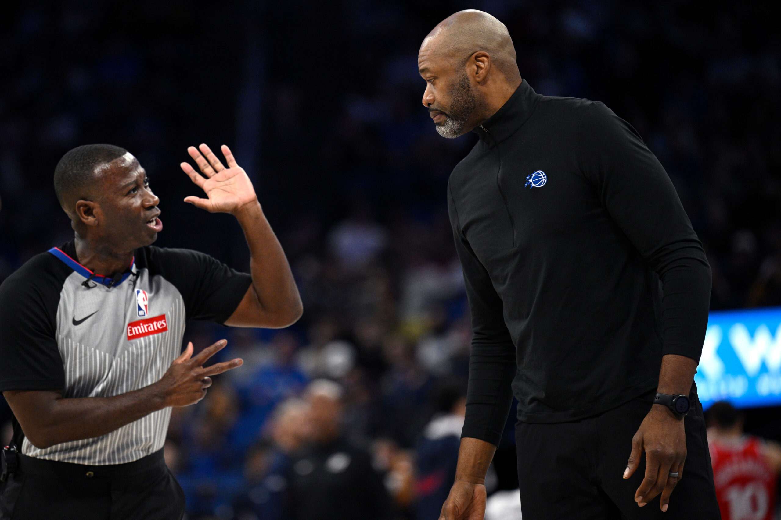 Orlando Magic head coach Jamahl Mosley, right, gets an explanation...