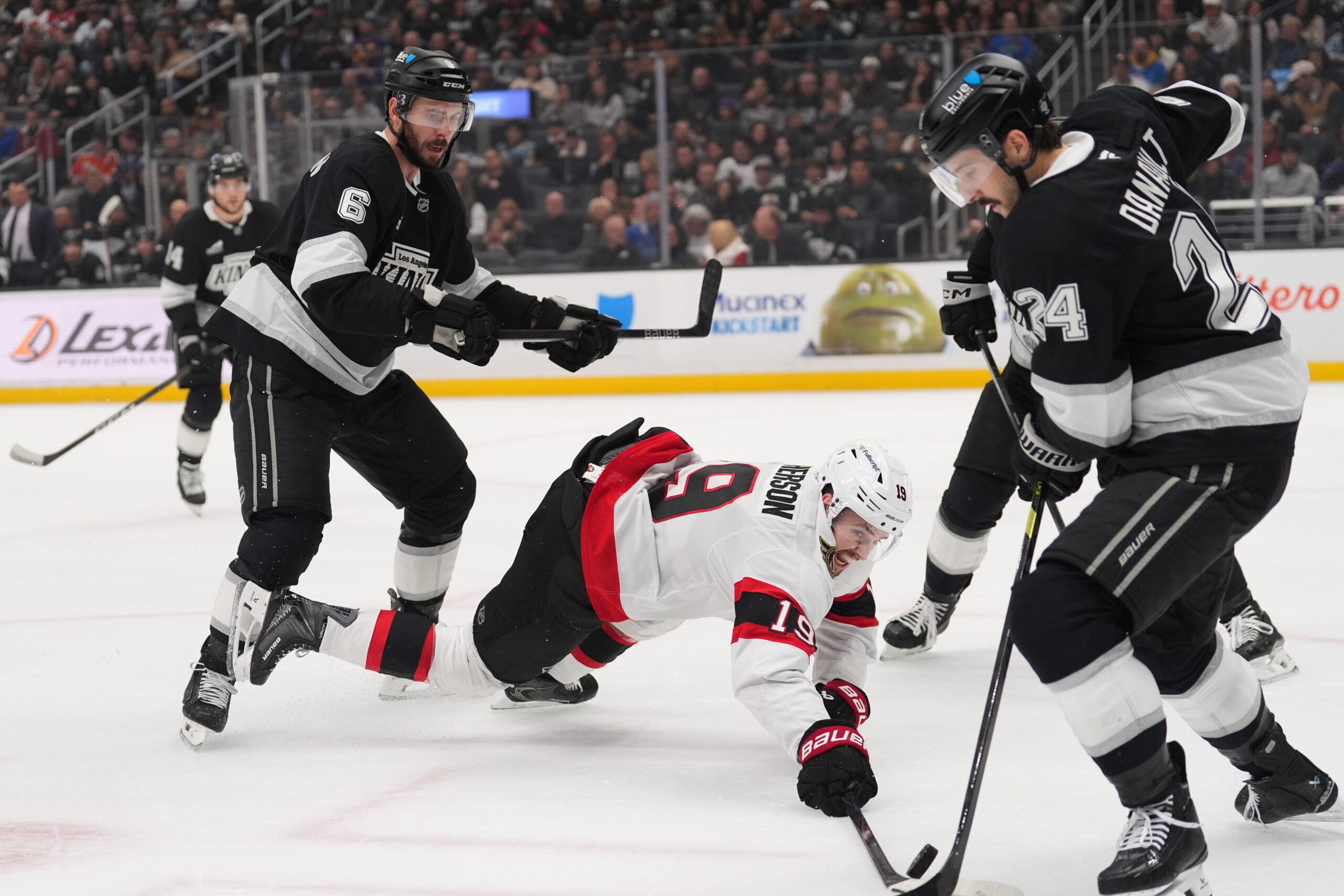 Ottawa Senators right wing Drake Batherson falls to the ice...