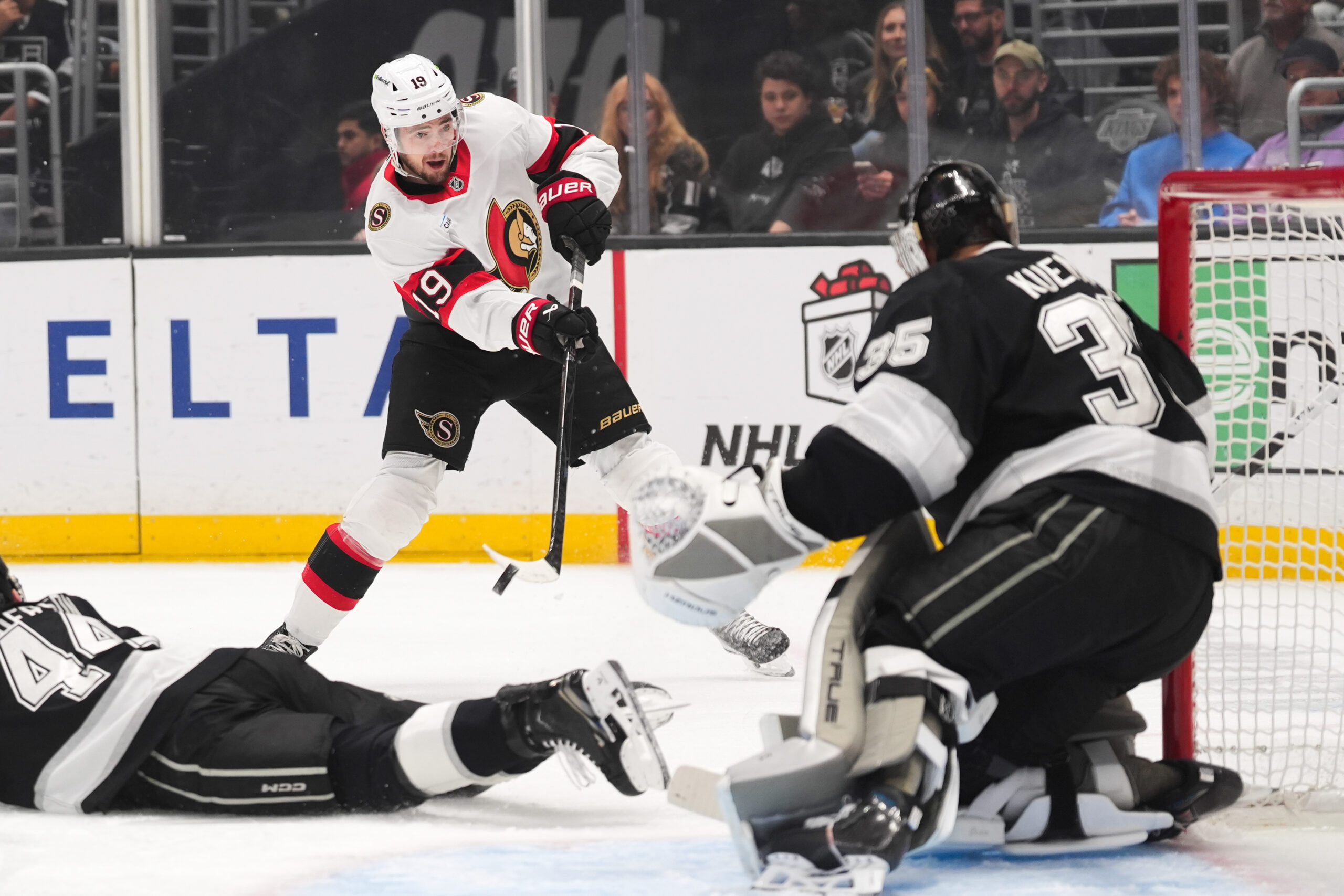 Kings goaltender Darcy Kuemper, right, makes a save against Ottawa...