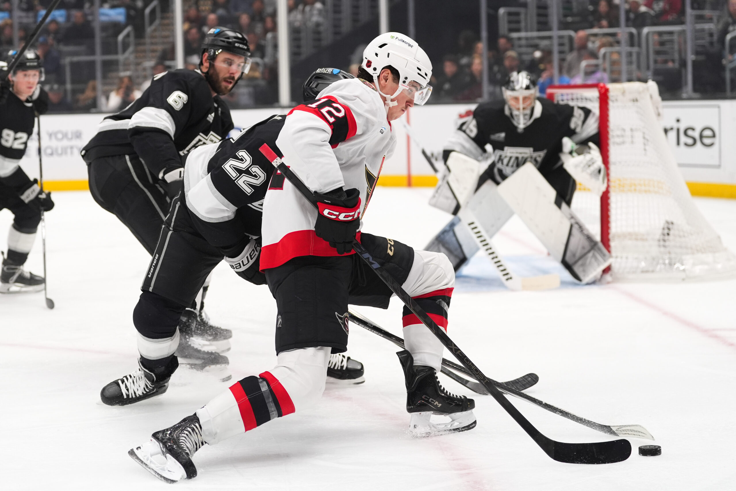 Ottawa Senators center Shane Pinto (12) moves the puck past...