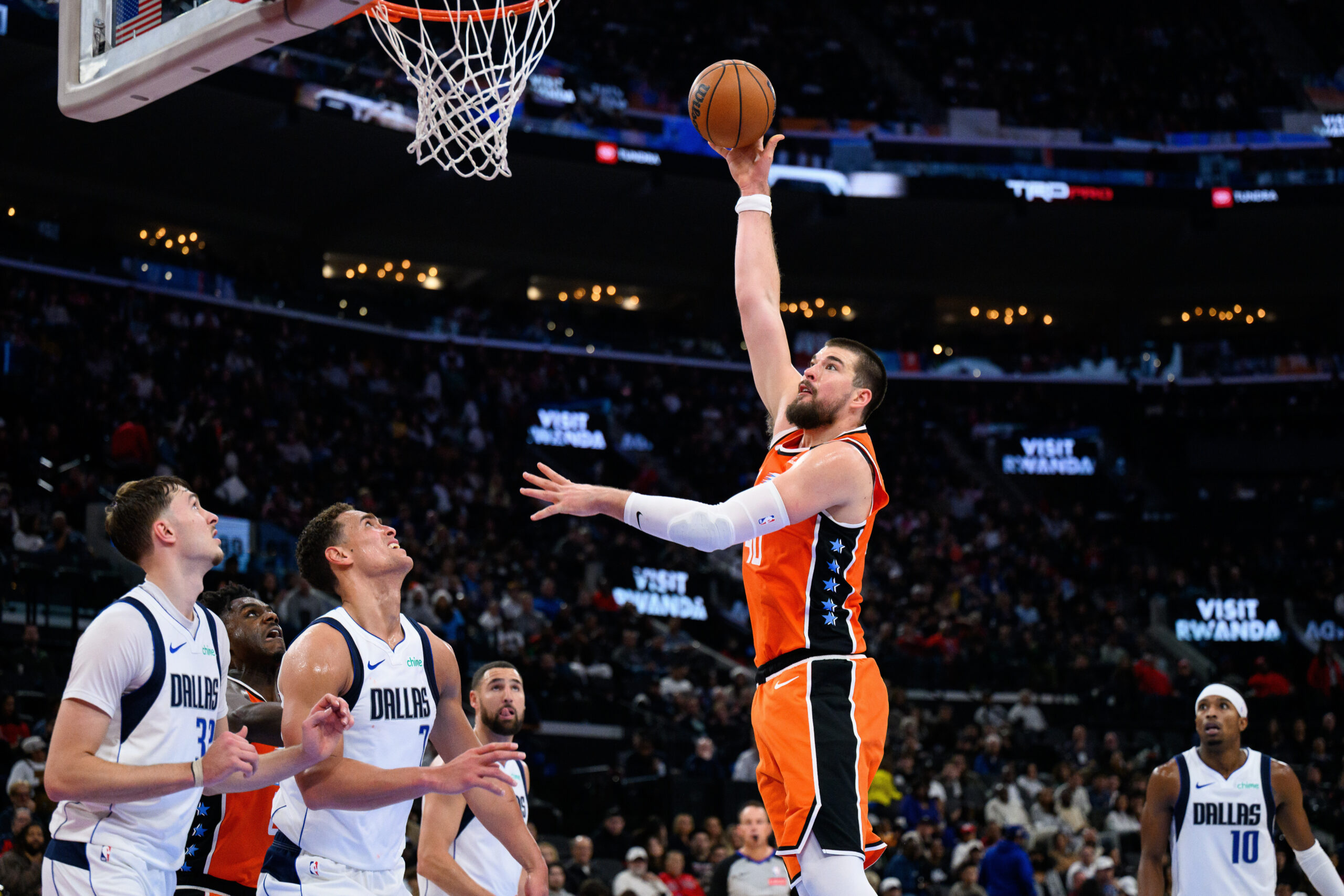 Clippers center Ivica Zubac, center, shoots during the second half...
