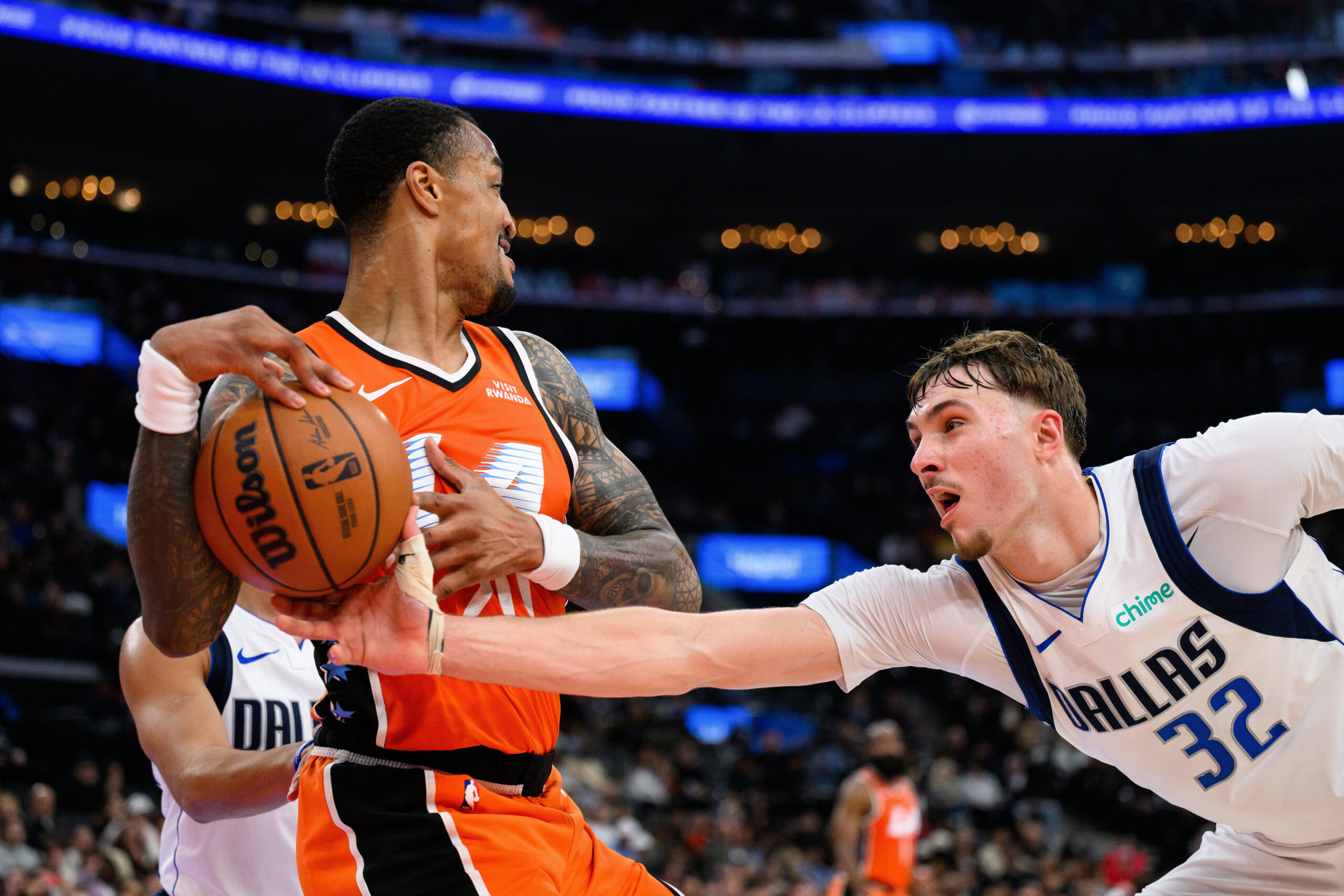 Dallas Mavericks forward Cooper Flagg (32) deflects the ball from...