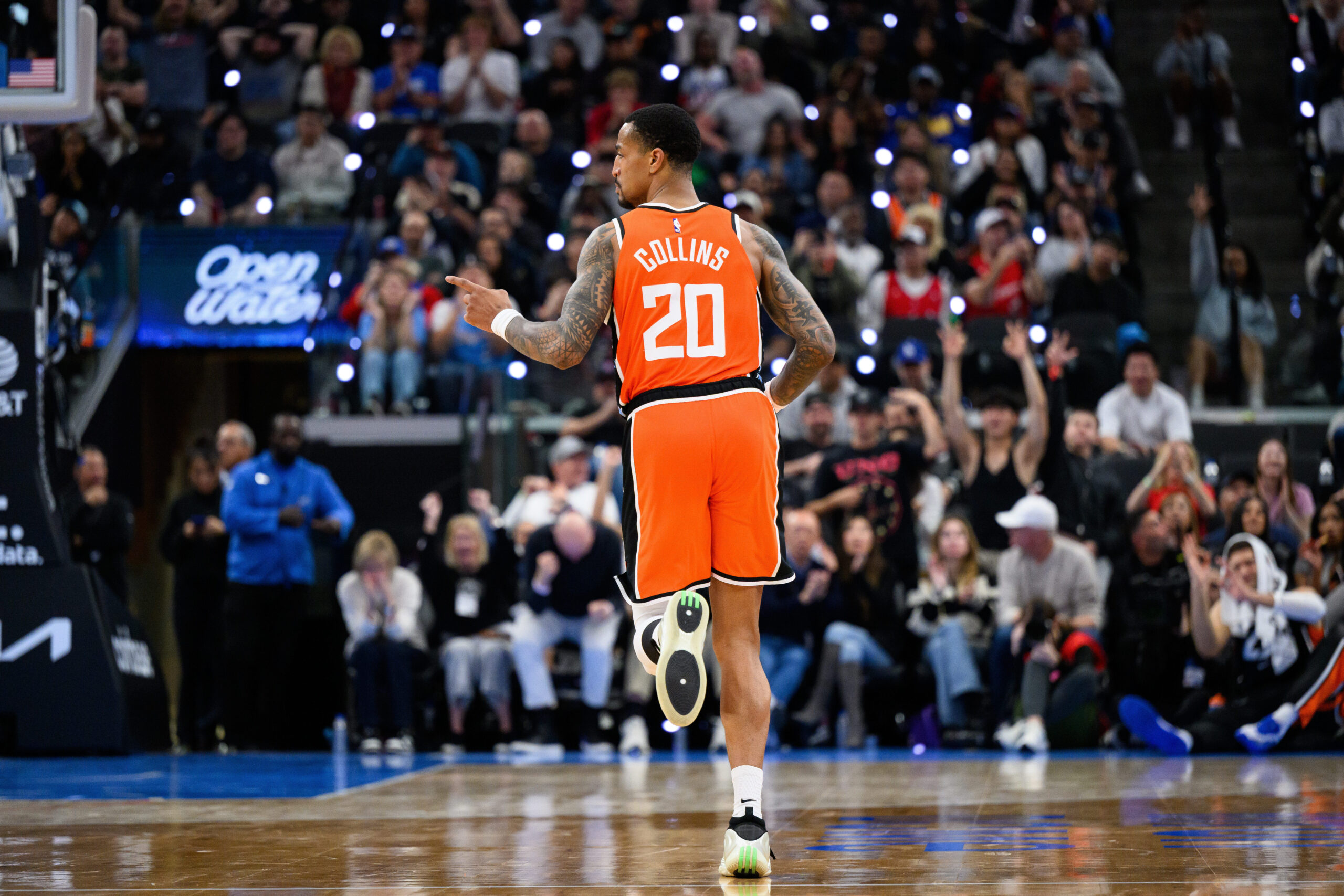 Clippers forward John Collins gestures after scoring during the second...