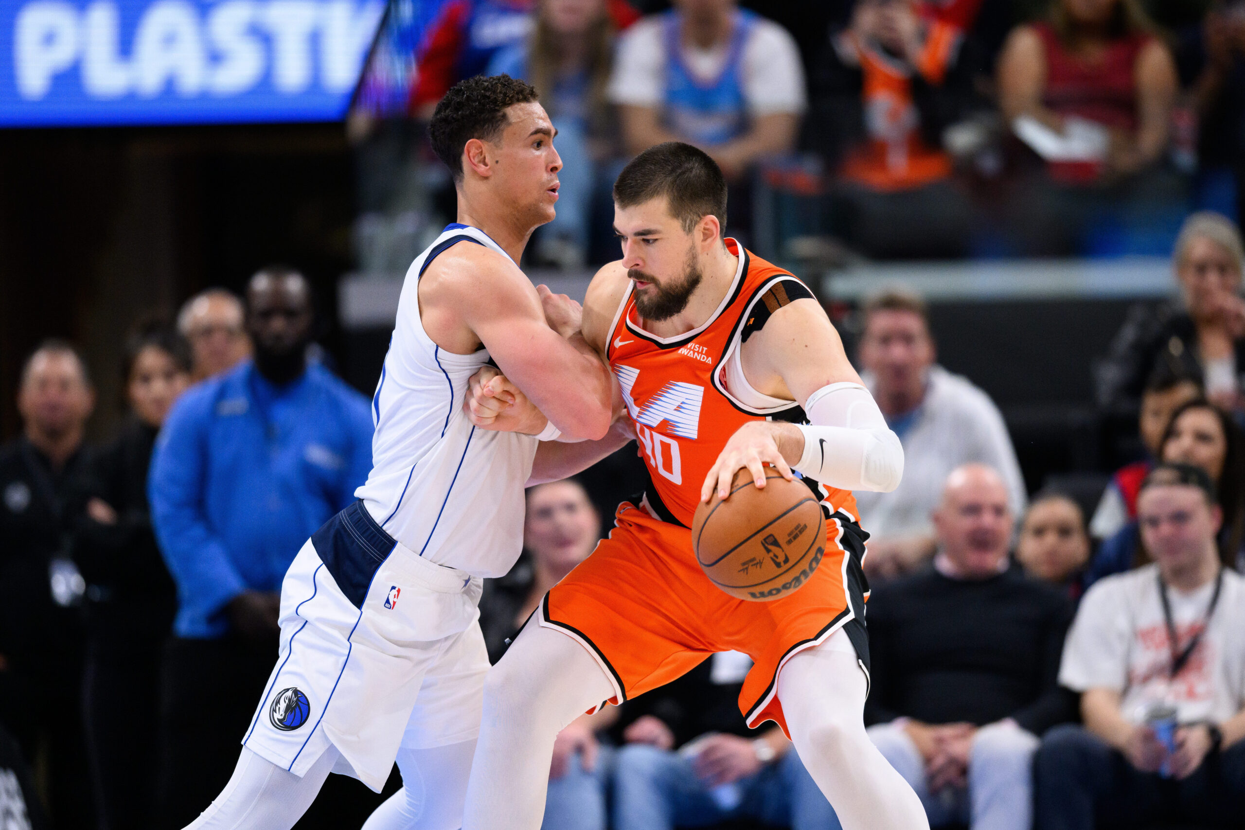 Clippers center Ivica Zubac, right, controls the ball while under...