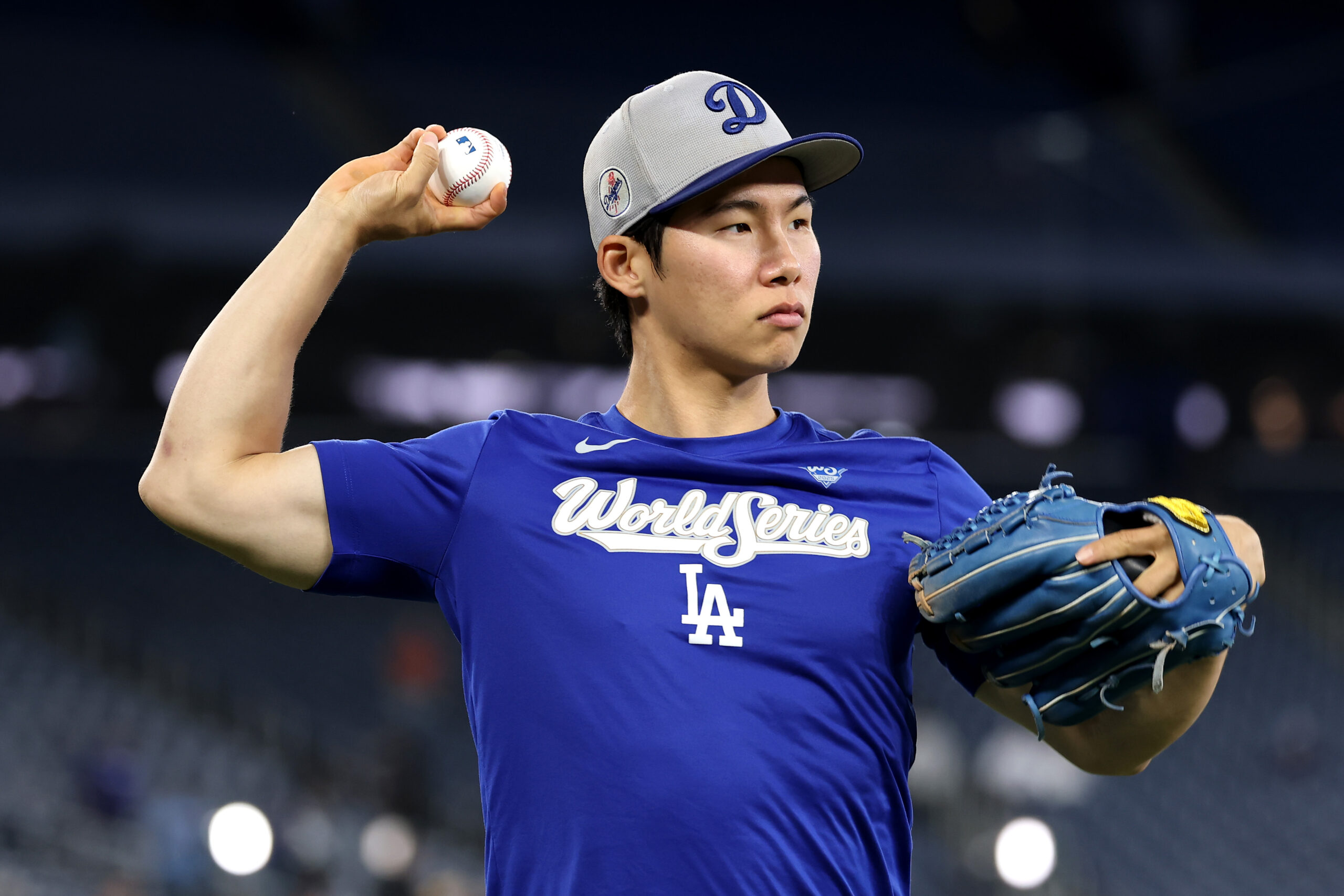 Dodgers infielder Hyeseong Kim warms up before Game 7 of...