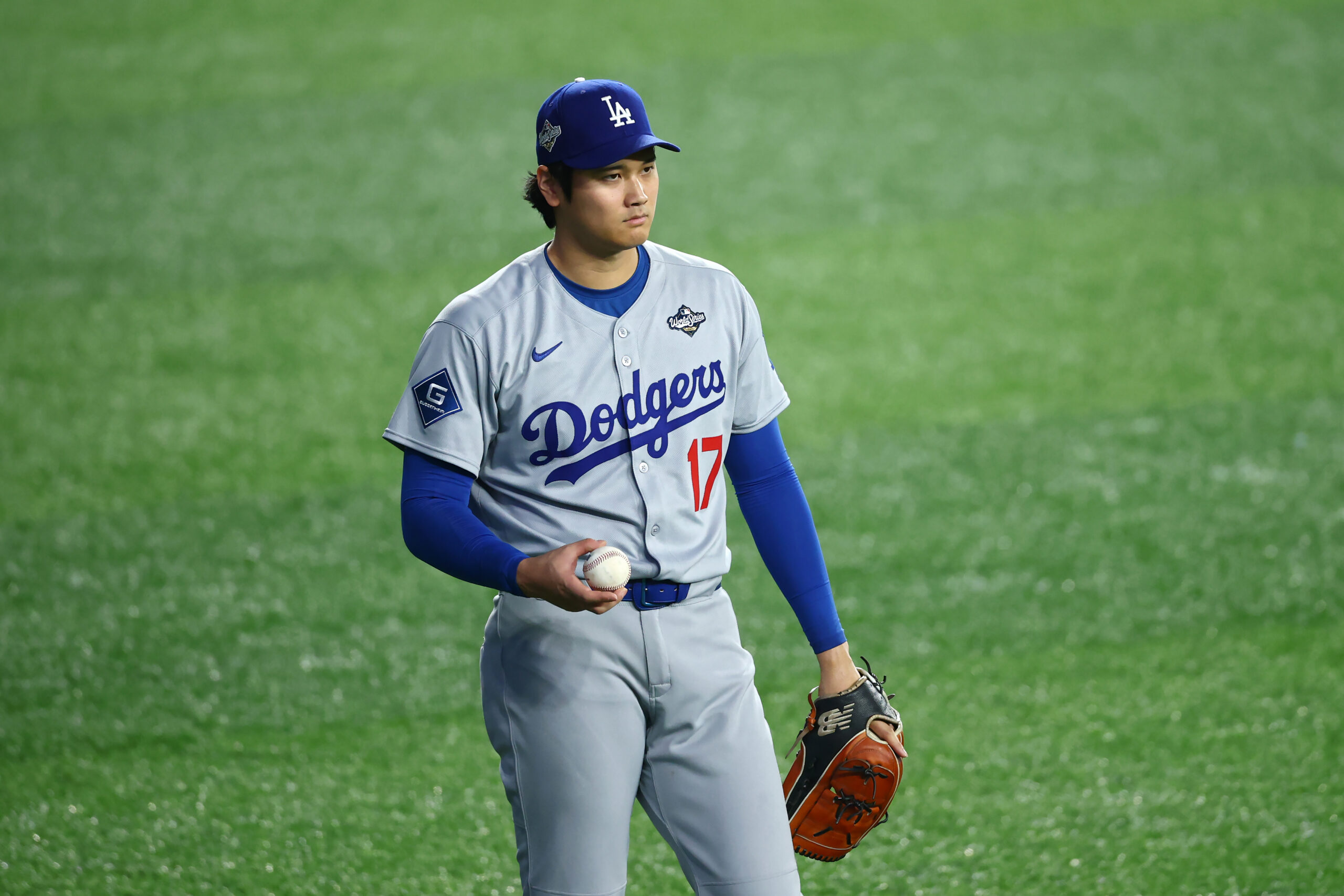 Dodgers starting pitcher/DH Shohei Ohtani warms up before Game 7...