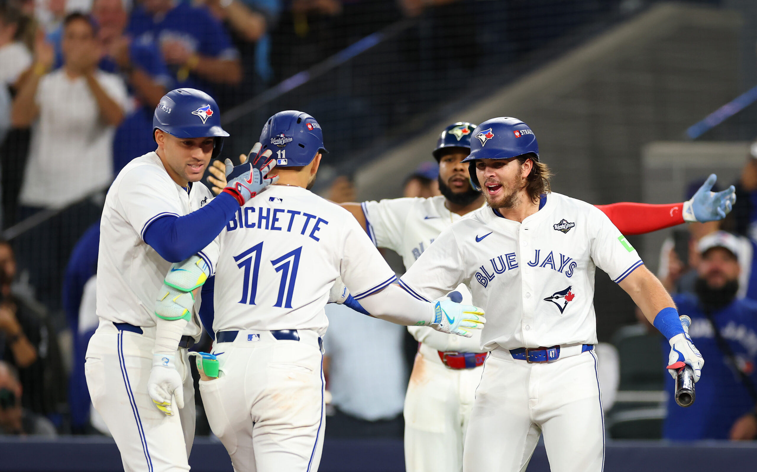 The Toronto Blue Jays’ Bo Bichette (11) celebrates with teammates...