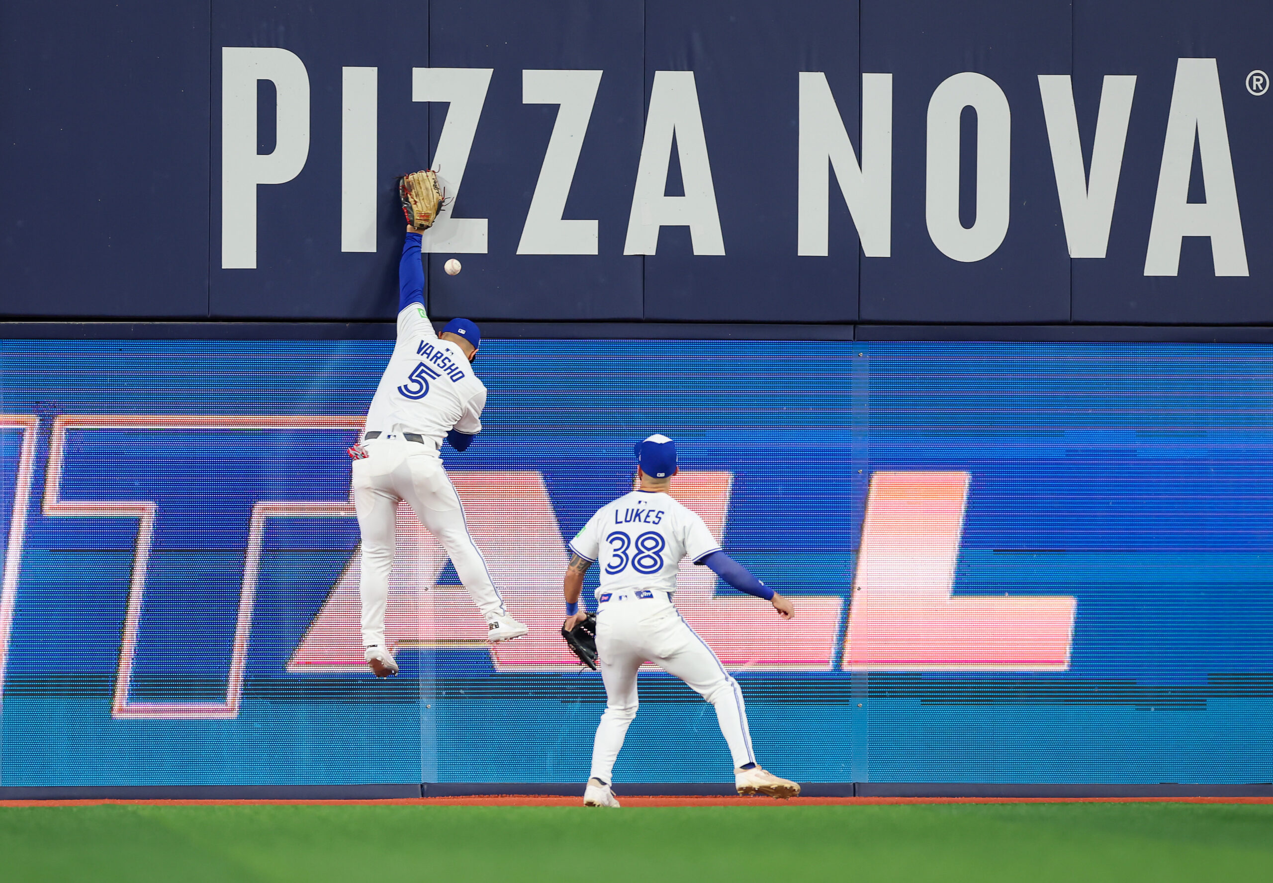Toronto Blue Jays outfielder Daulton Varsho (5) is unable to...