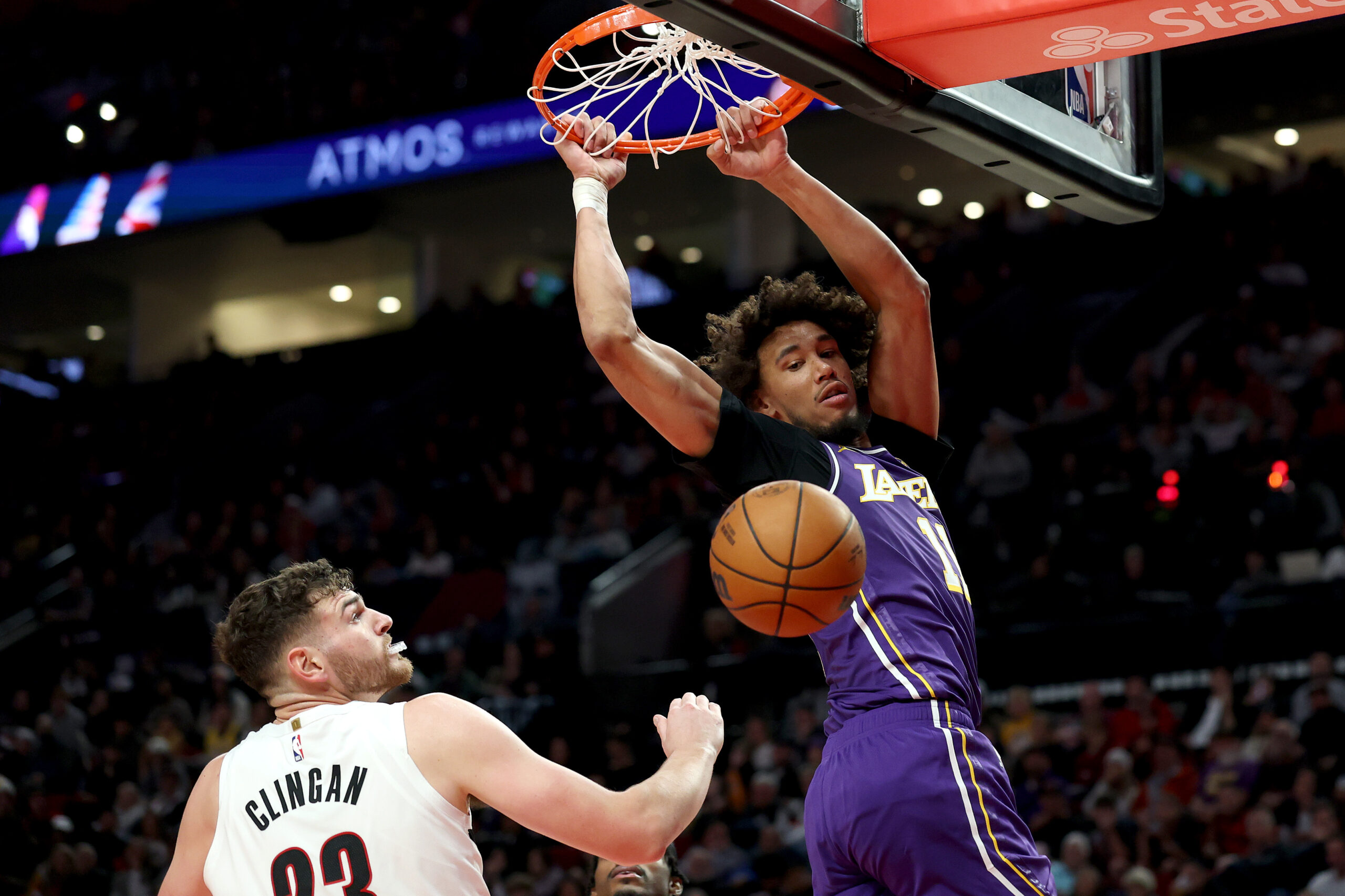 Lakers center Jaxson Hayes dunks in front of Portland Trail...
