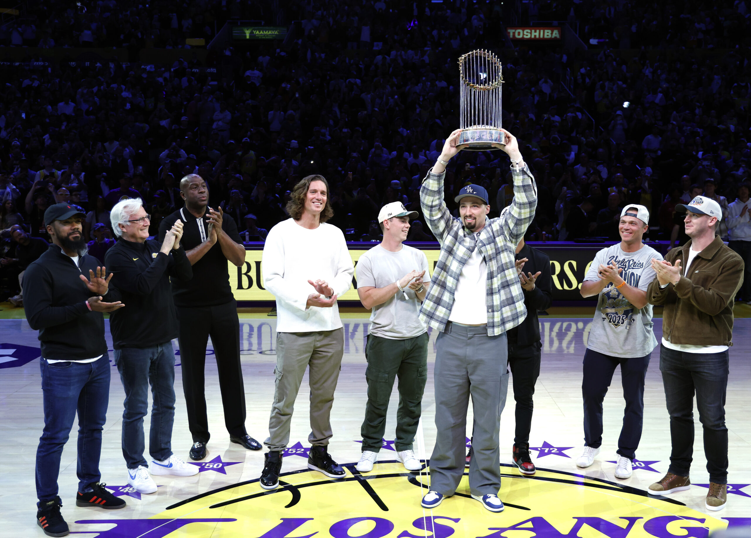 From left, Dodgers pitcher Blake Snell holds up the World...
