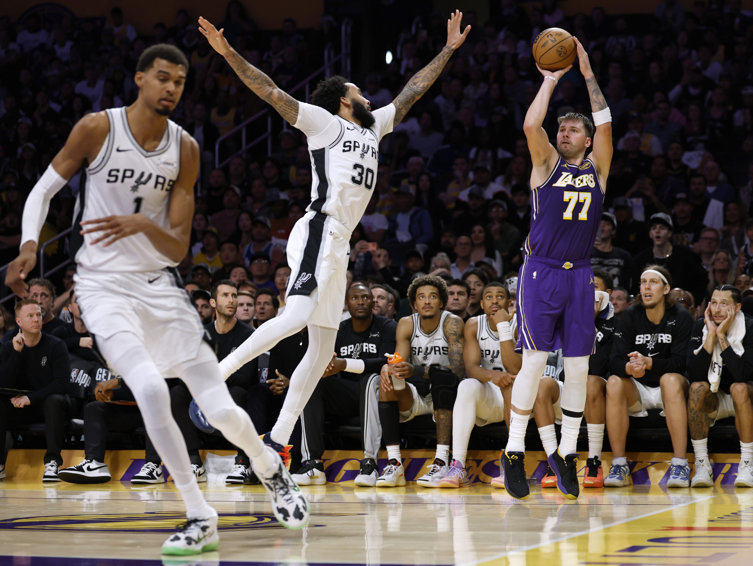 Lakers star Luka Doncic takes a shot in front of...