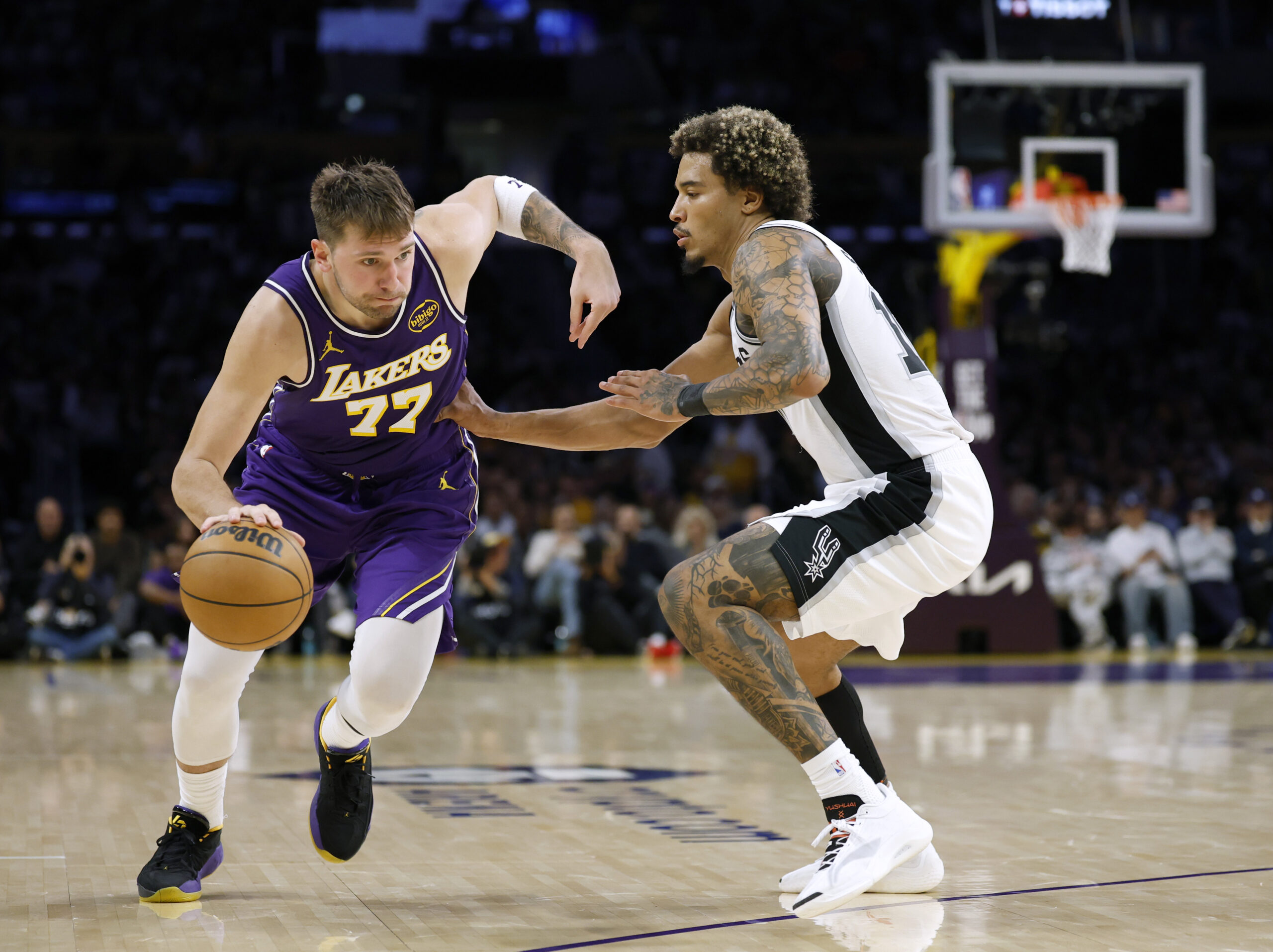 Lakers star Luka Doncic drives to the basket as the...
