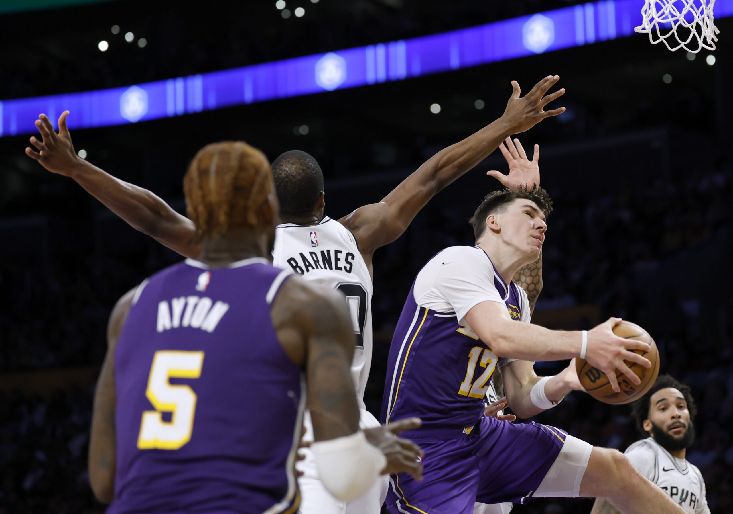 Lakers forward Jake LaRavia, right, reacts as he is fouled...