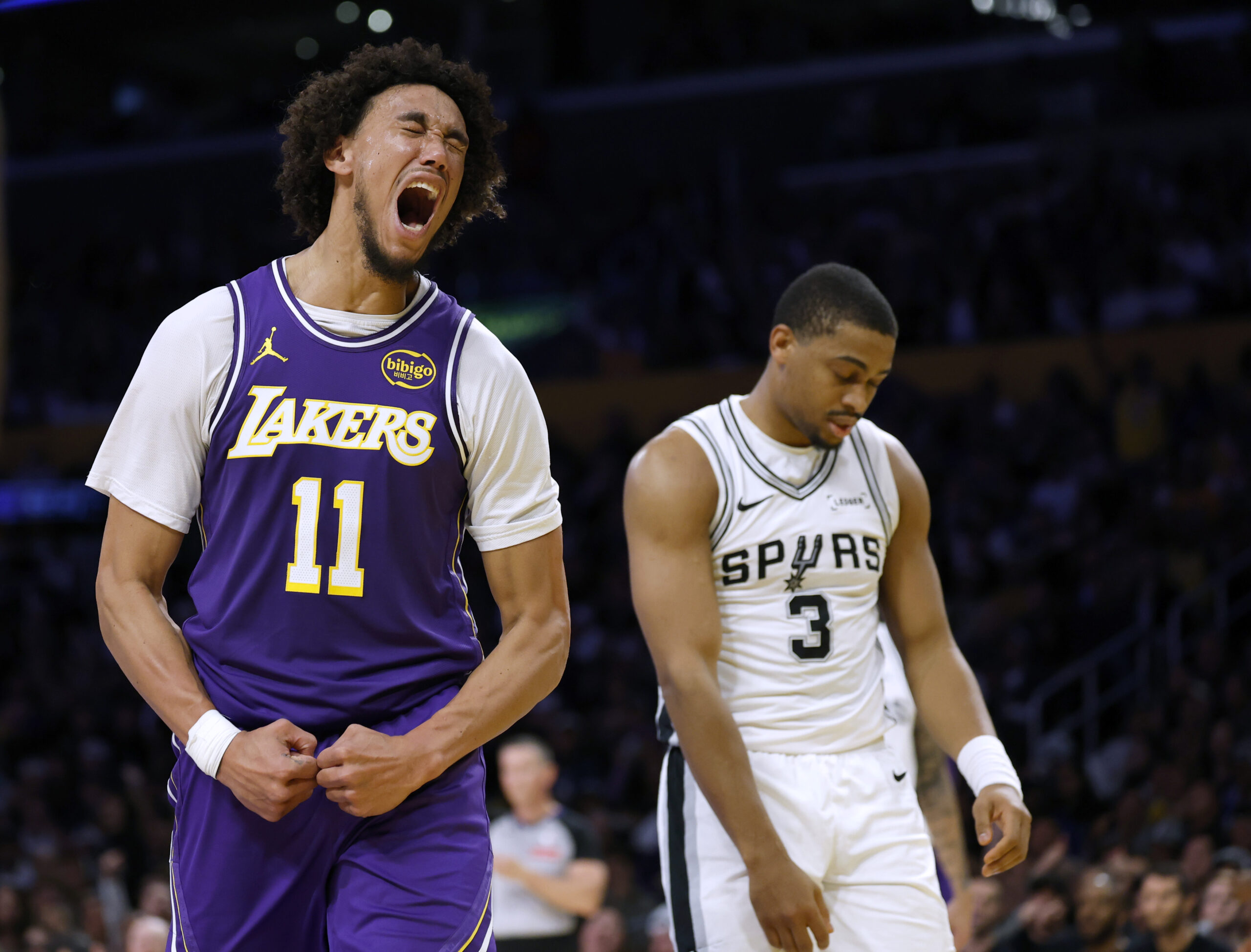 Lakers center Jaxson Hayes, left, celebrates after his dunk in...