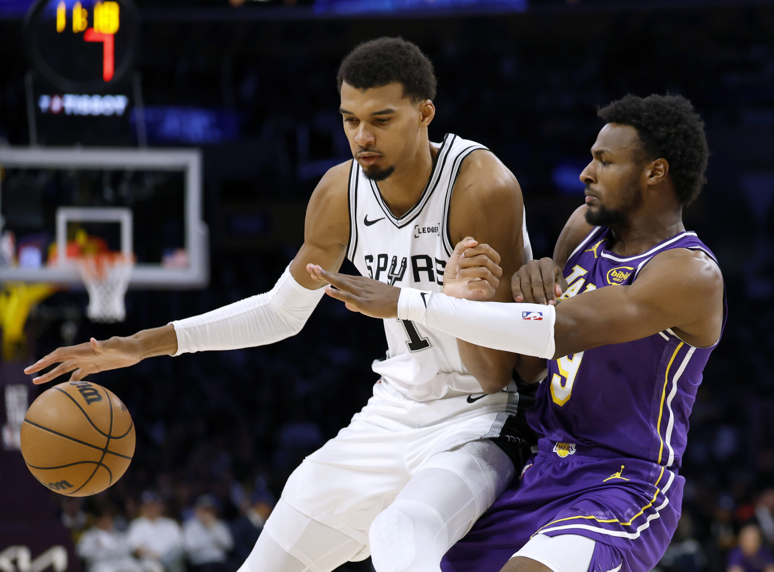 San Antonio Spurs star Victor Wembanyama, left, backs into Lakers...