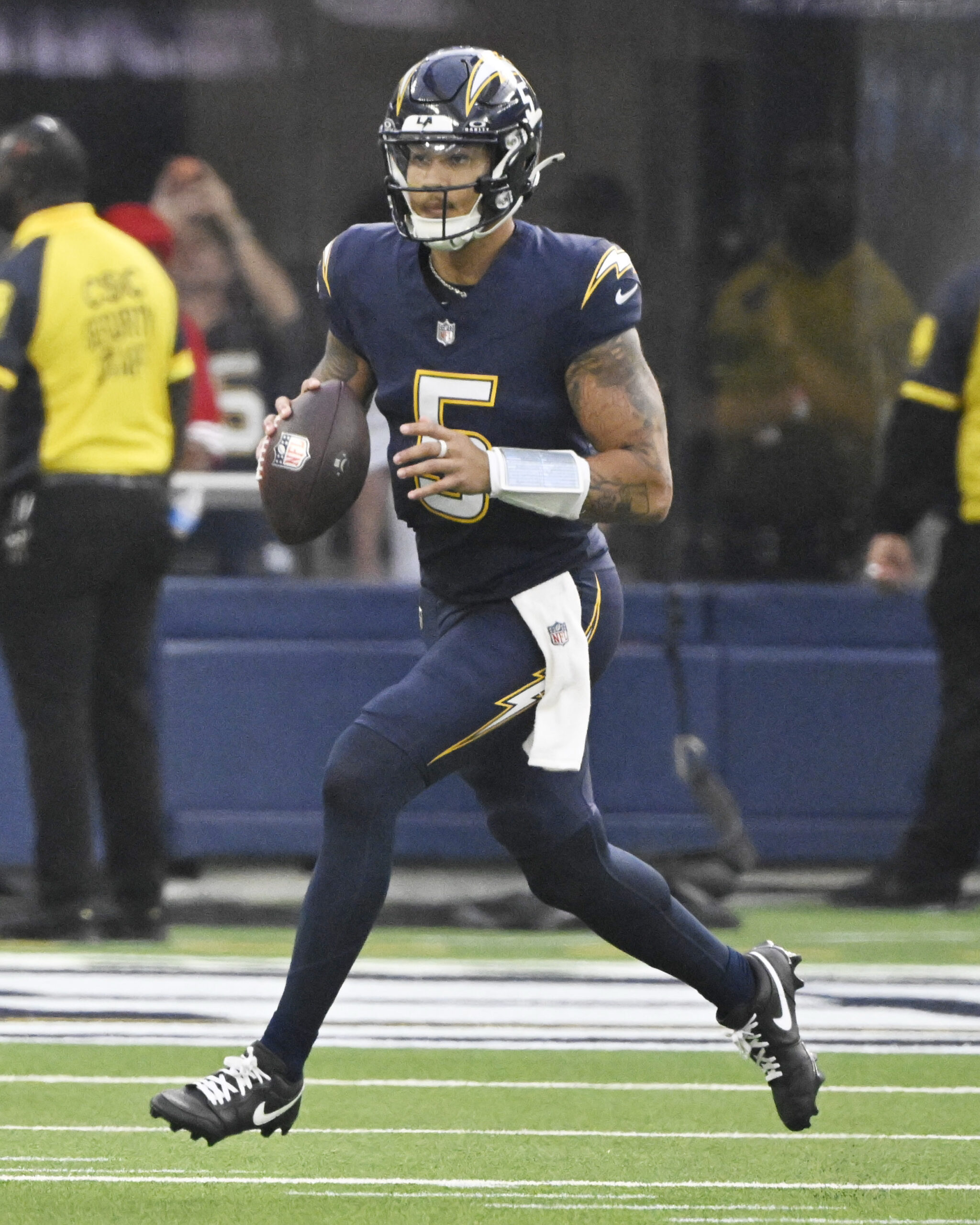 Quarterback Trey Lance #5 of the Los Angeles Chargers scrambles...