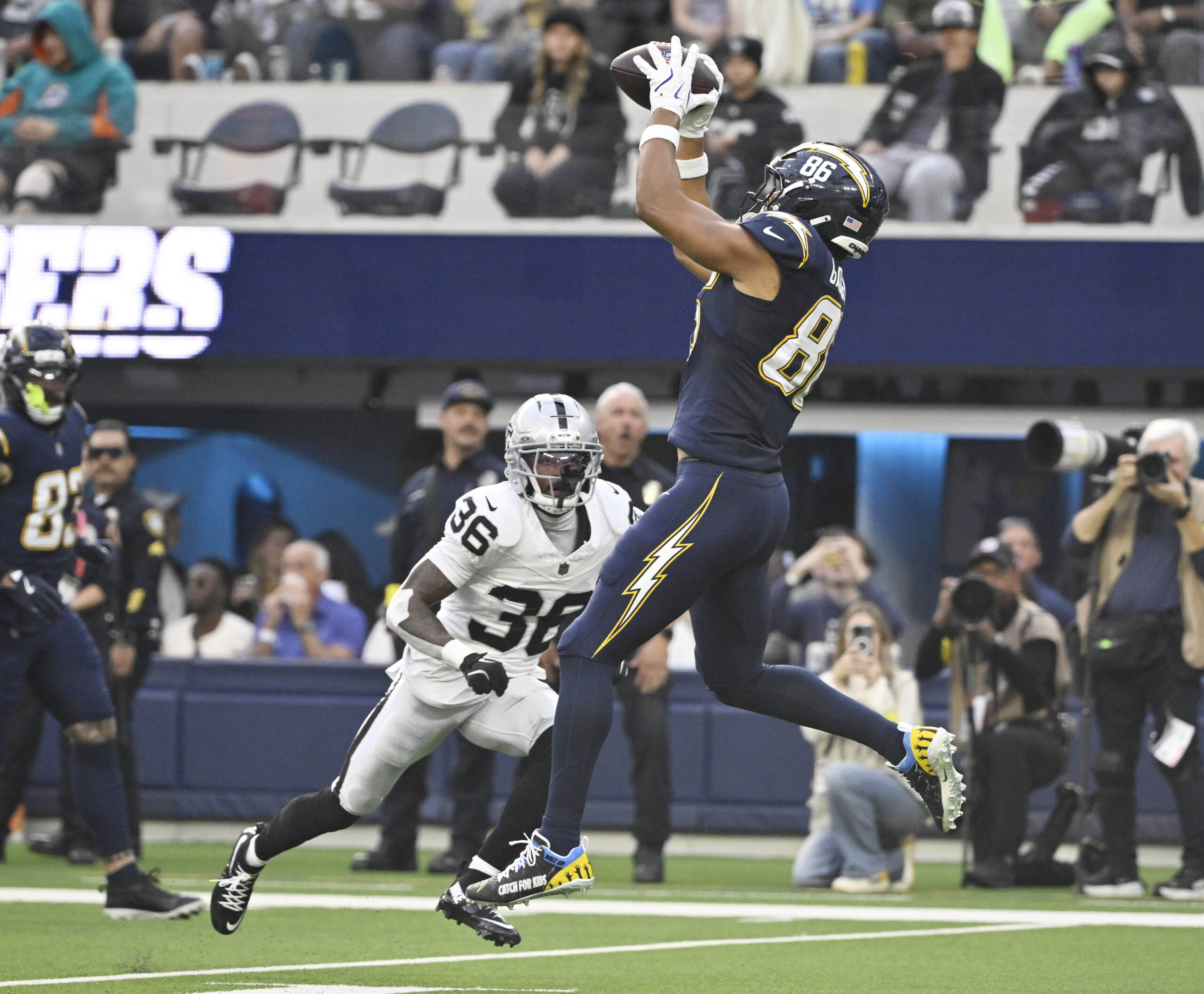 Tight end Oronde Gadsden II #86 of the Chargers catches...