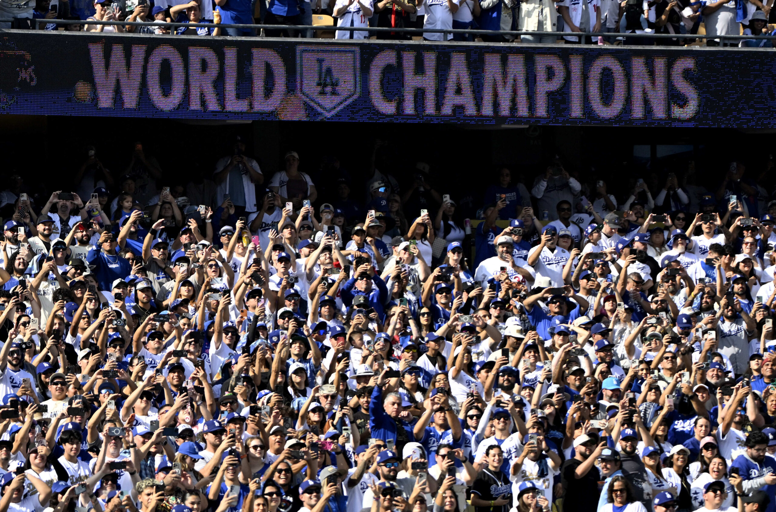 Dodger fans look on during a celebration of the Los...