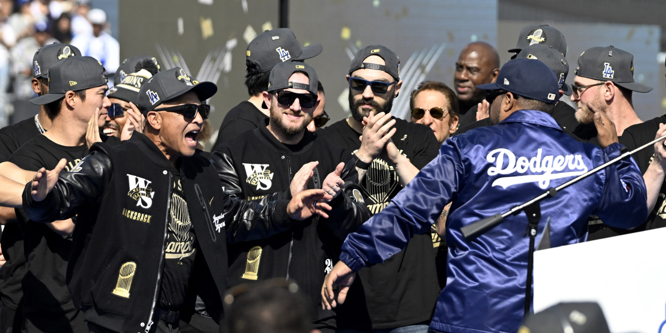 Manager Dave Roberts, left, greets Ice Cube during a celebration...