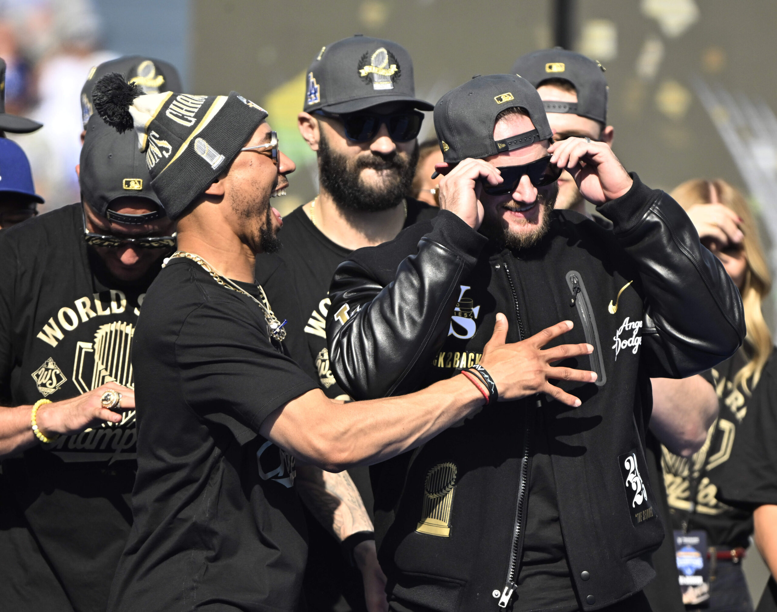 Mookie Betts, left, reacts as Max Muncy of the Los...