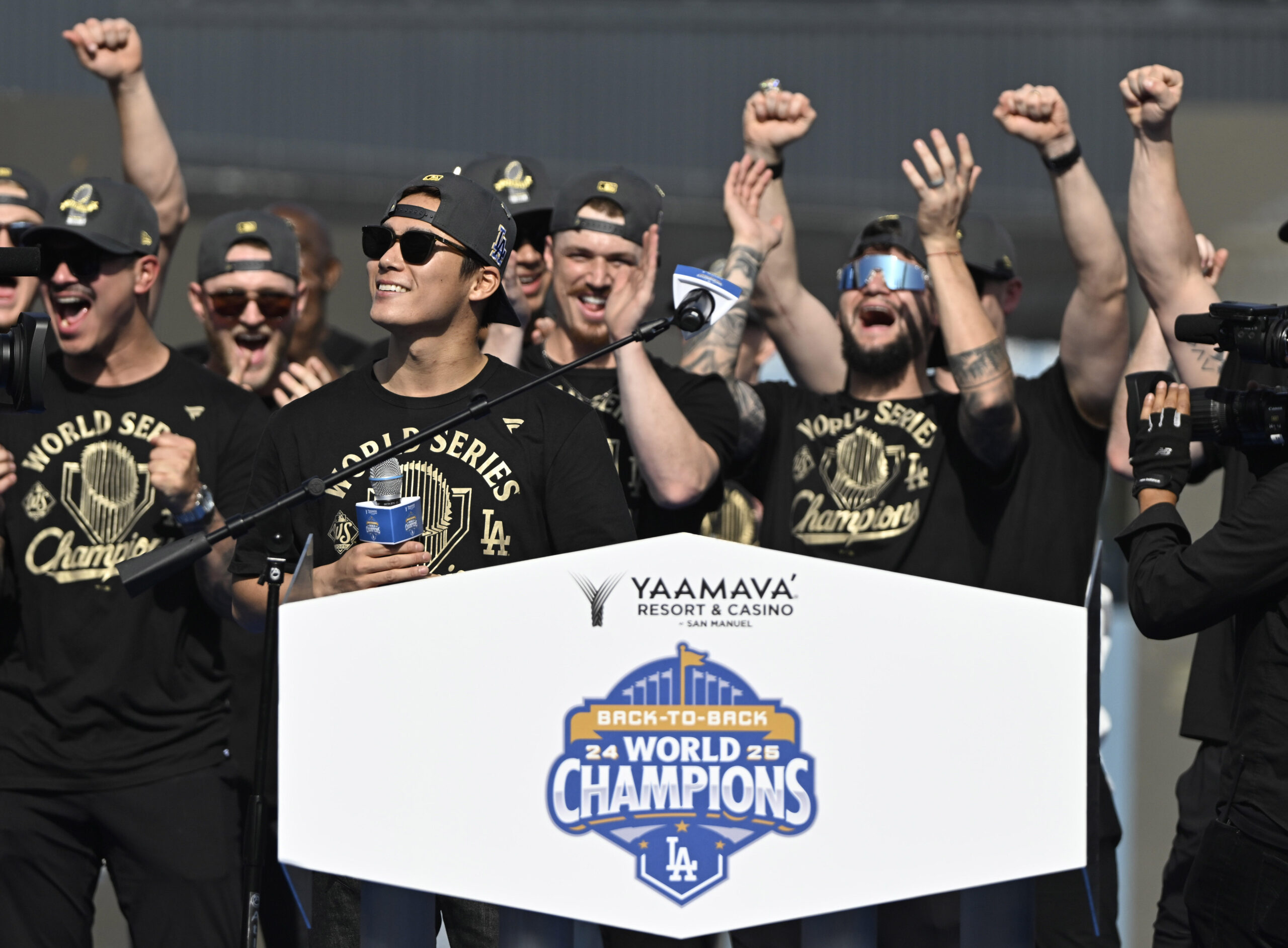 Yoshinobu Yamamoto of the Los Angeles Dodgers reacts to cheers...
